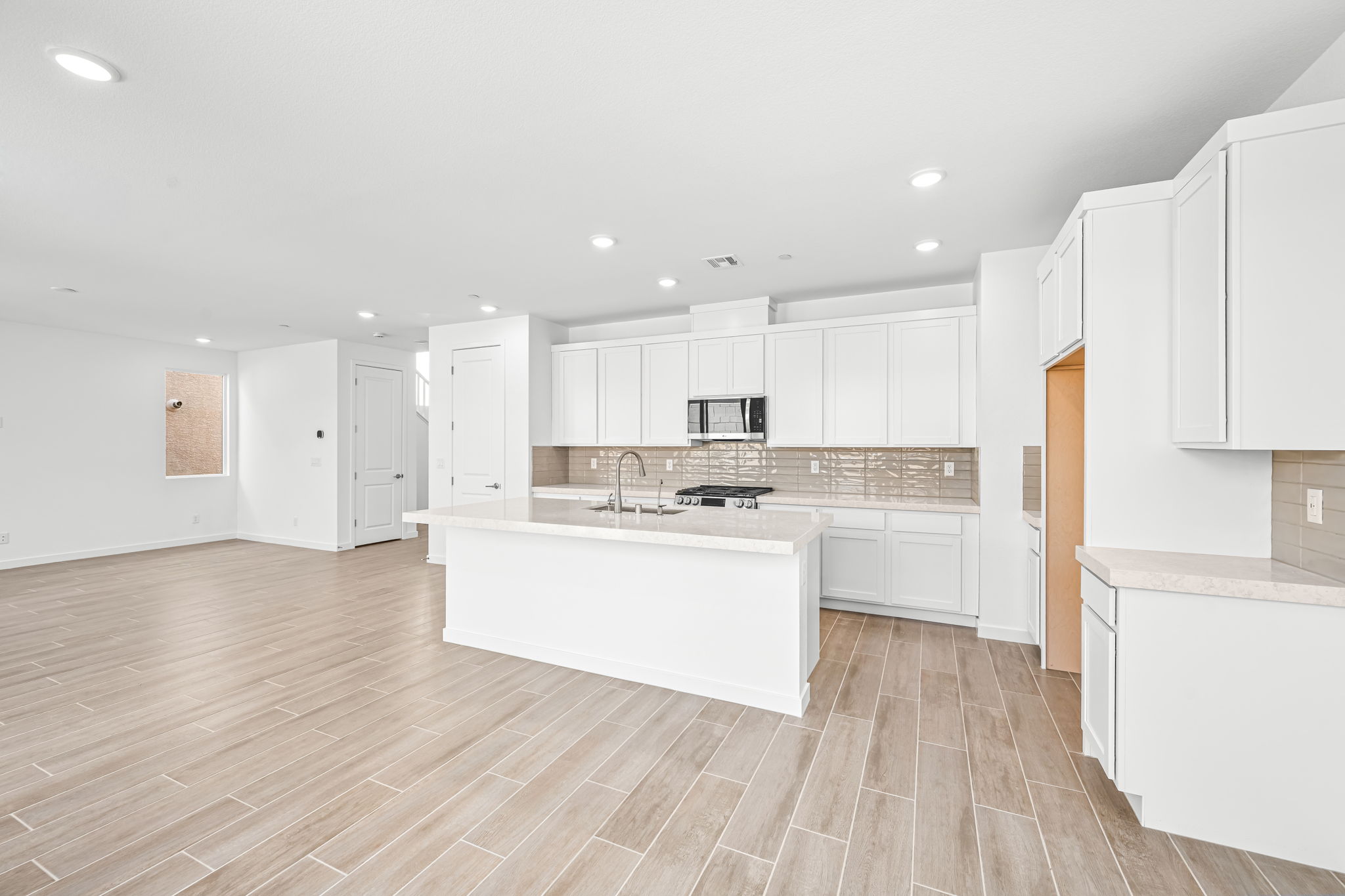 A kitchen with white cabinets.