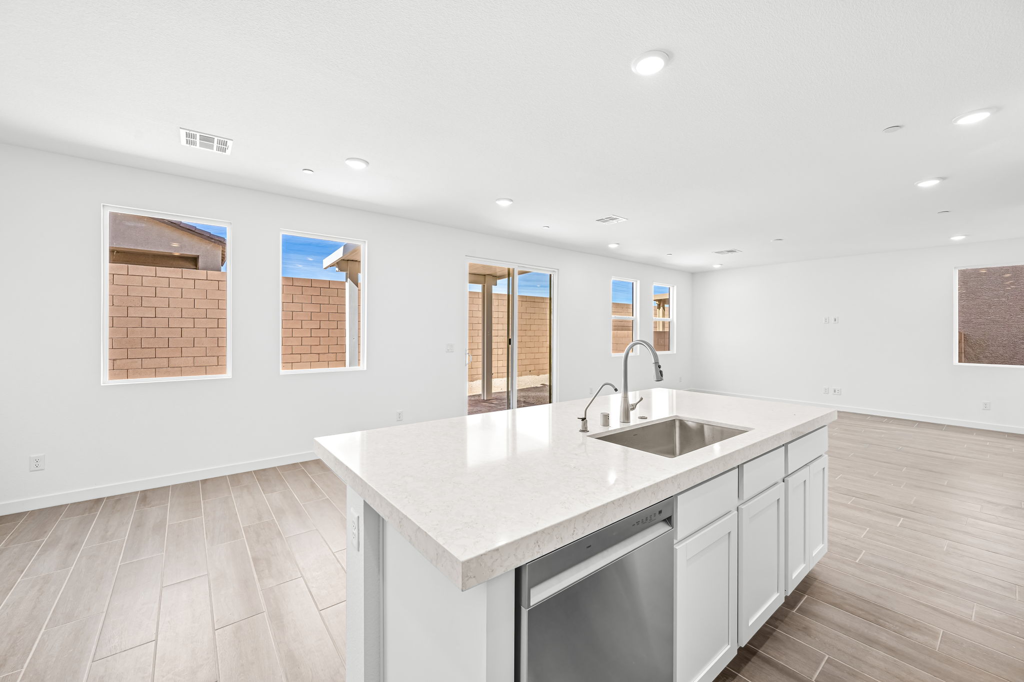 A kitchen with white cabinets.