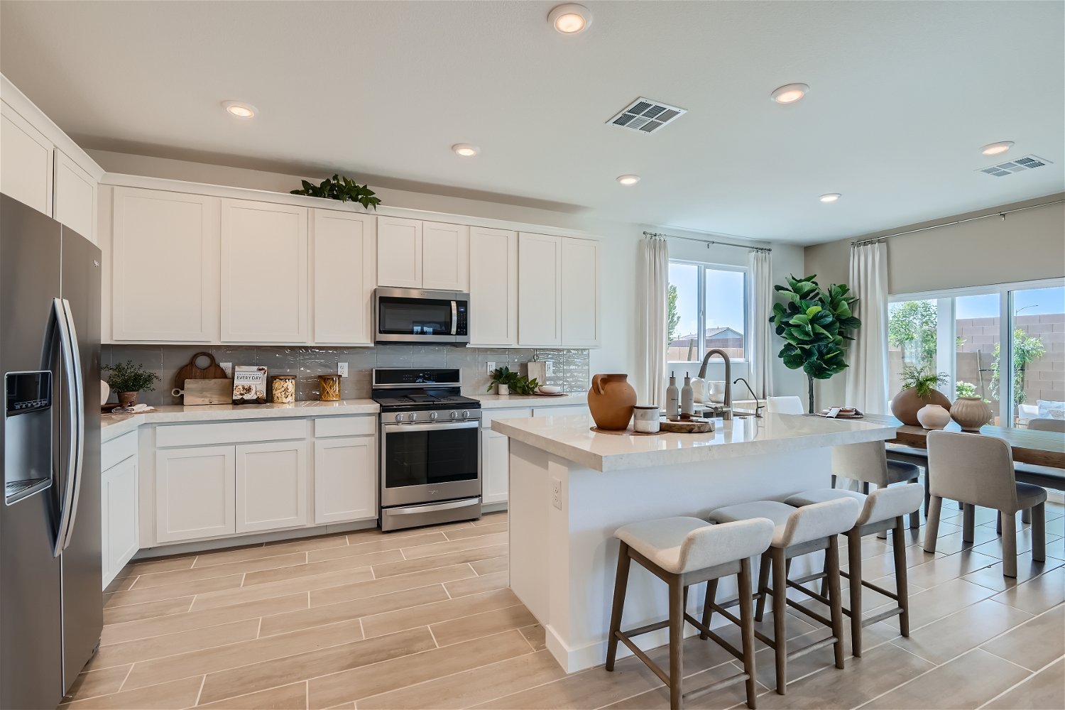 A kitchen with white cabinets.