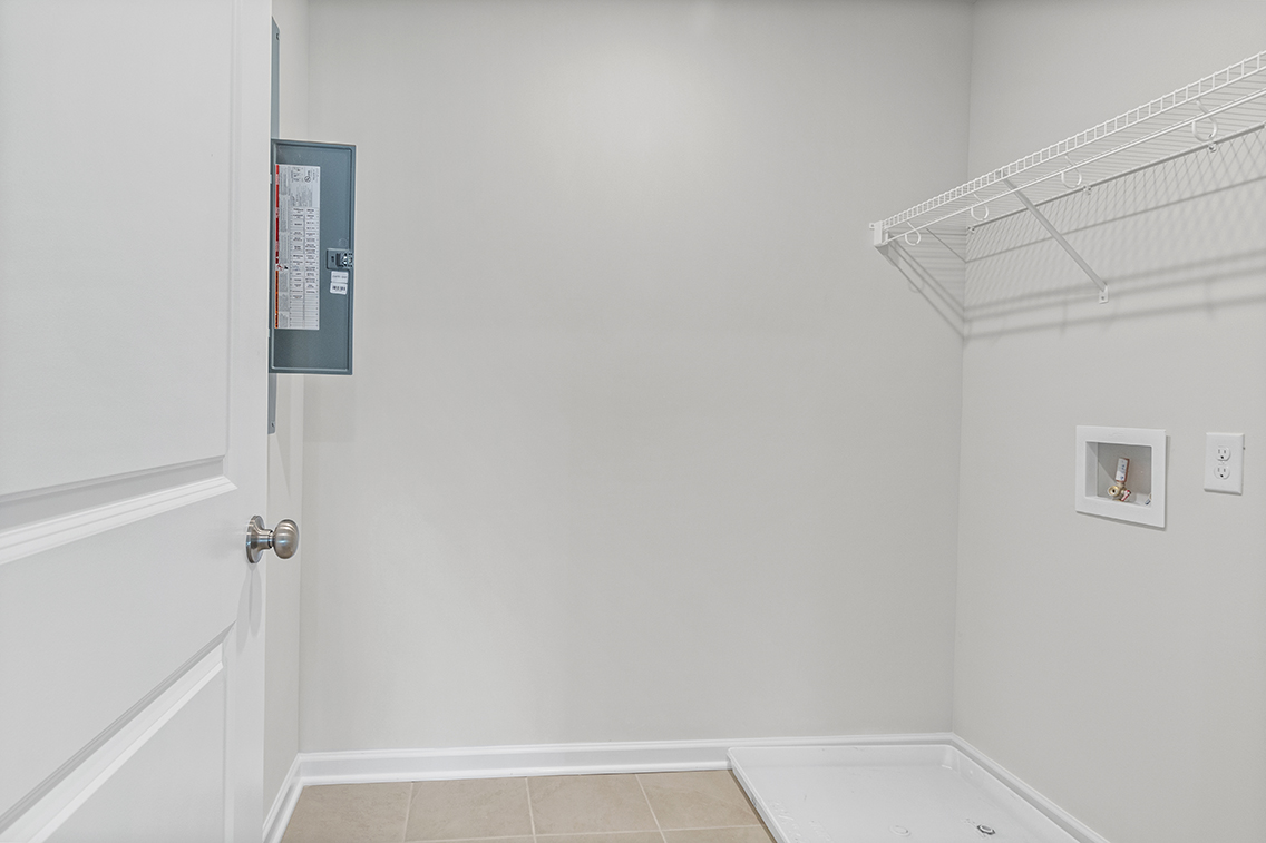 A white bathroom with a white door.