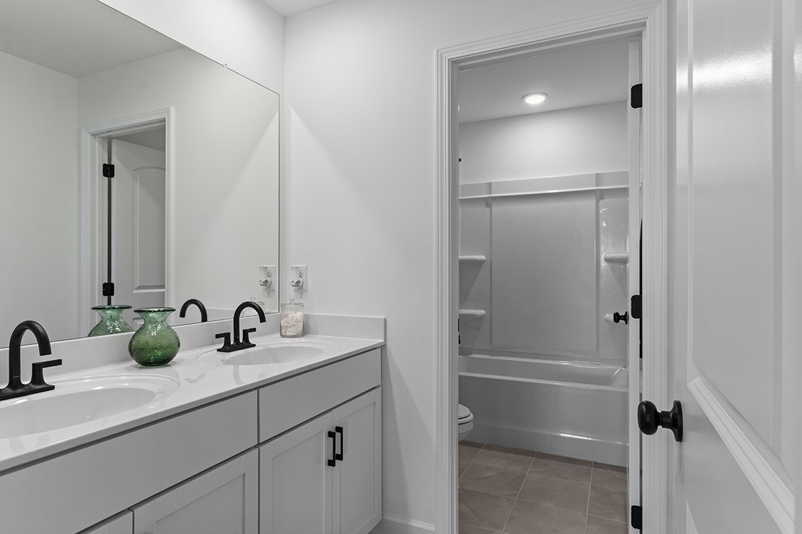 A bathroom with a sink and a shower.