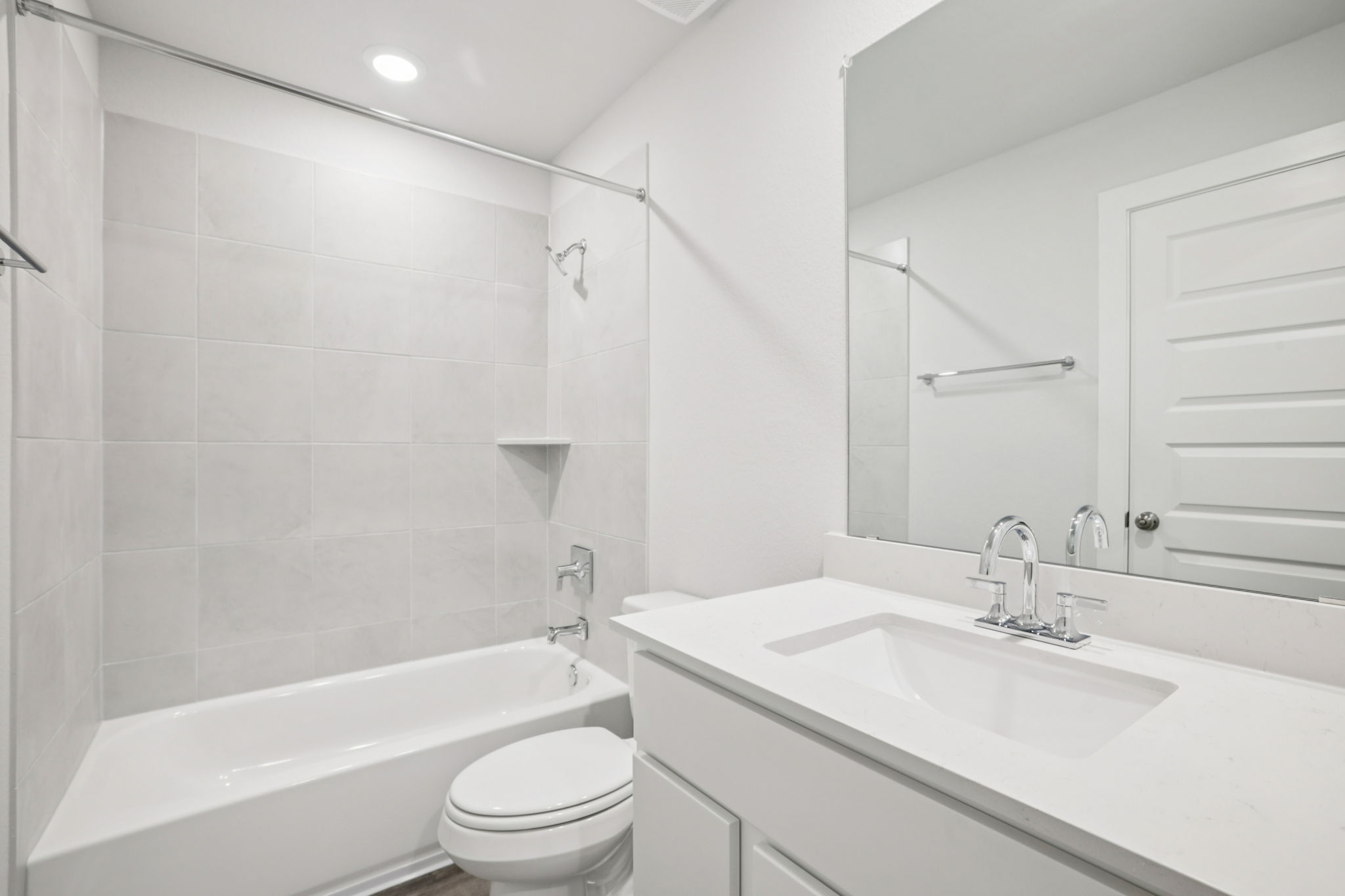 A bathroom with a tub sink and toilet.