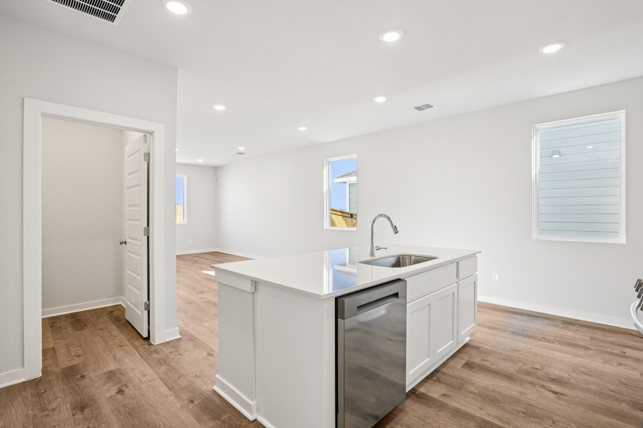 A kitchen with white cabinets.