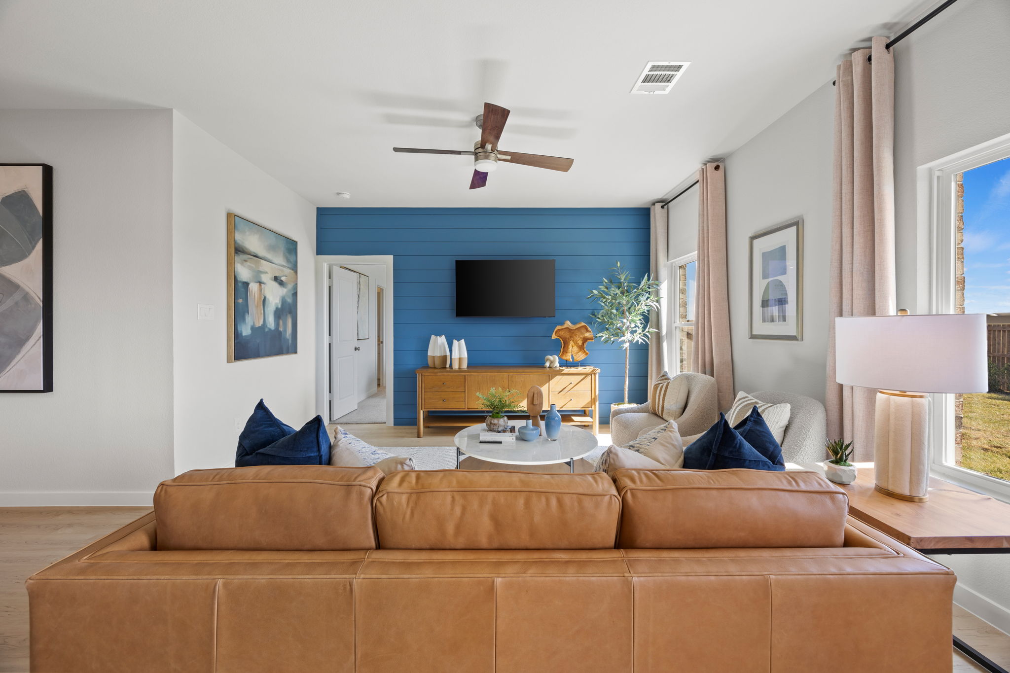 A living room with a couch and a tv.