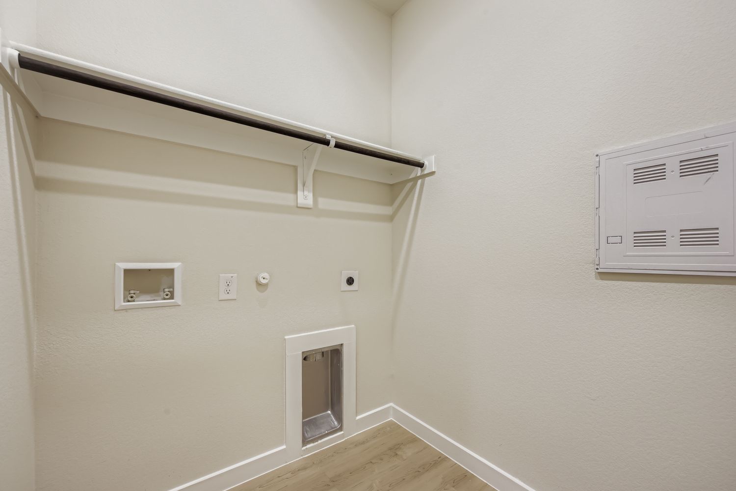 A white room with a wood floor and a white ceiling.