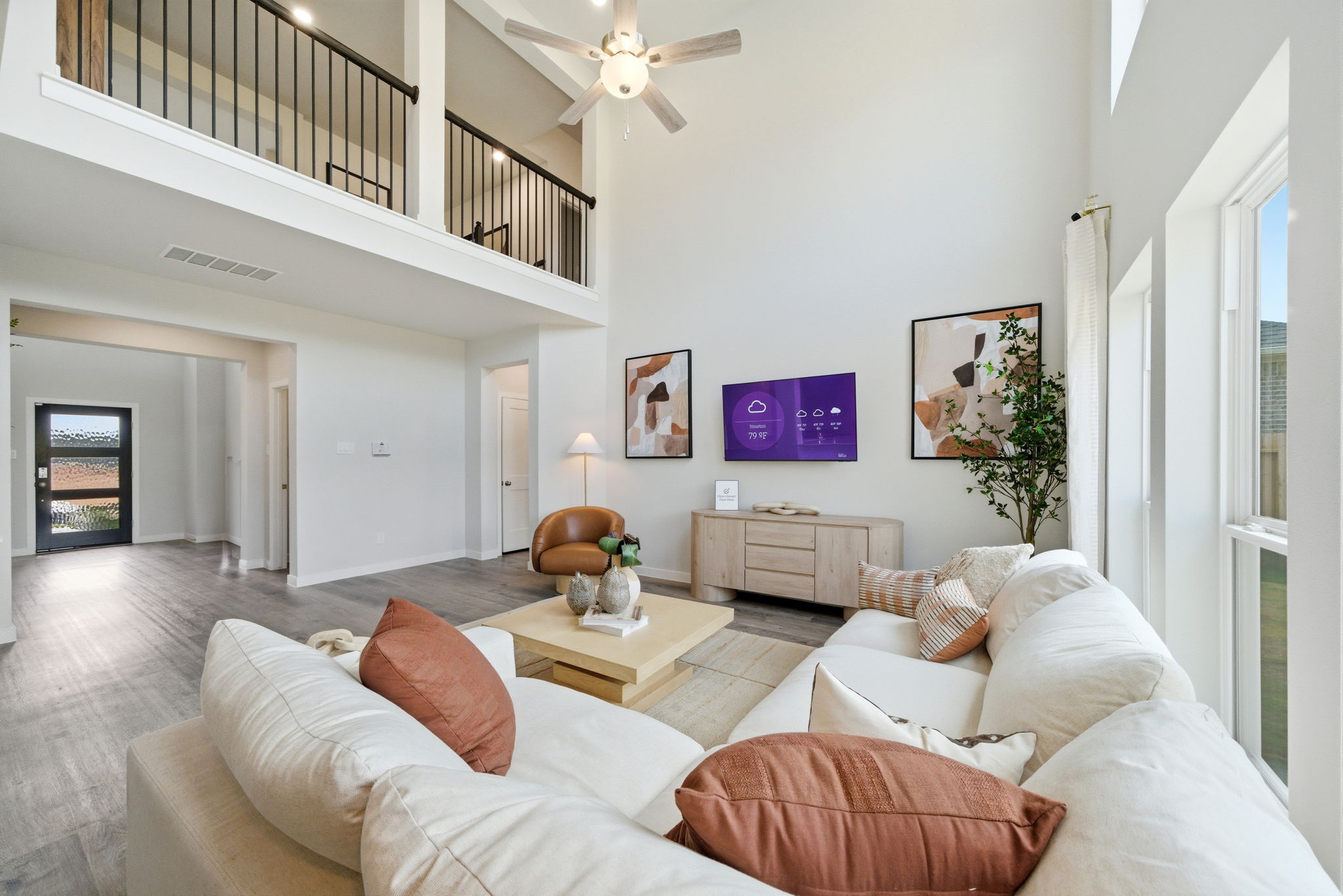 A living room with a large television.