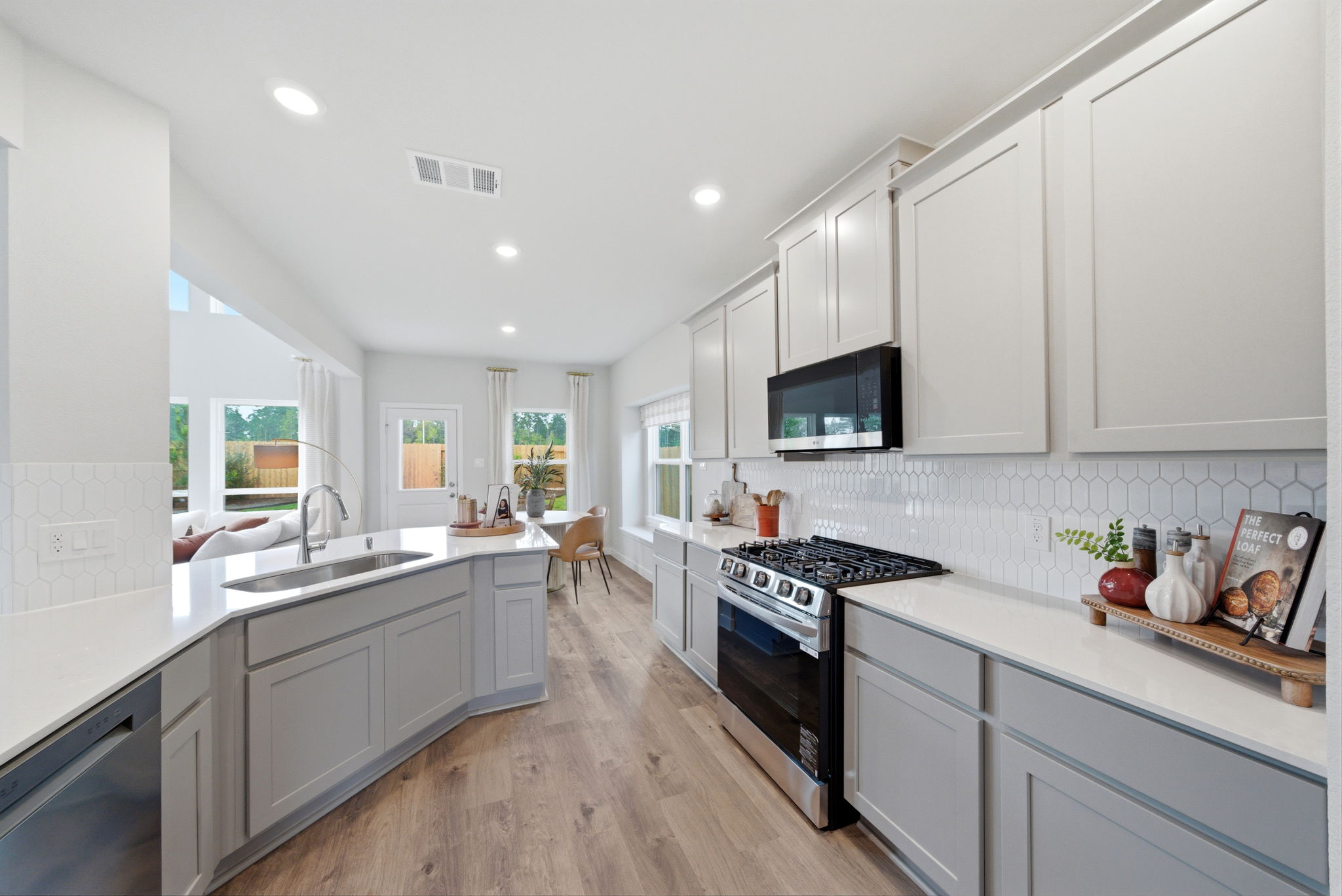 A kitchen with white cabinets.