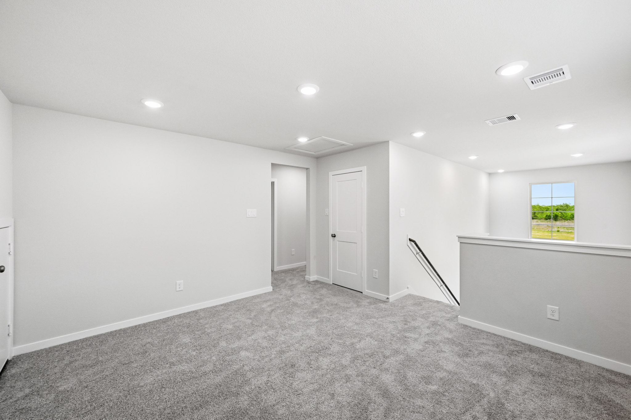 A room with white walls and a window.
