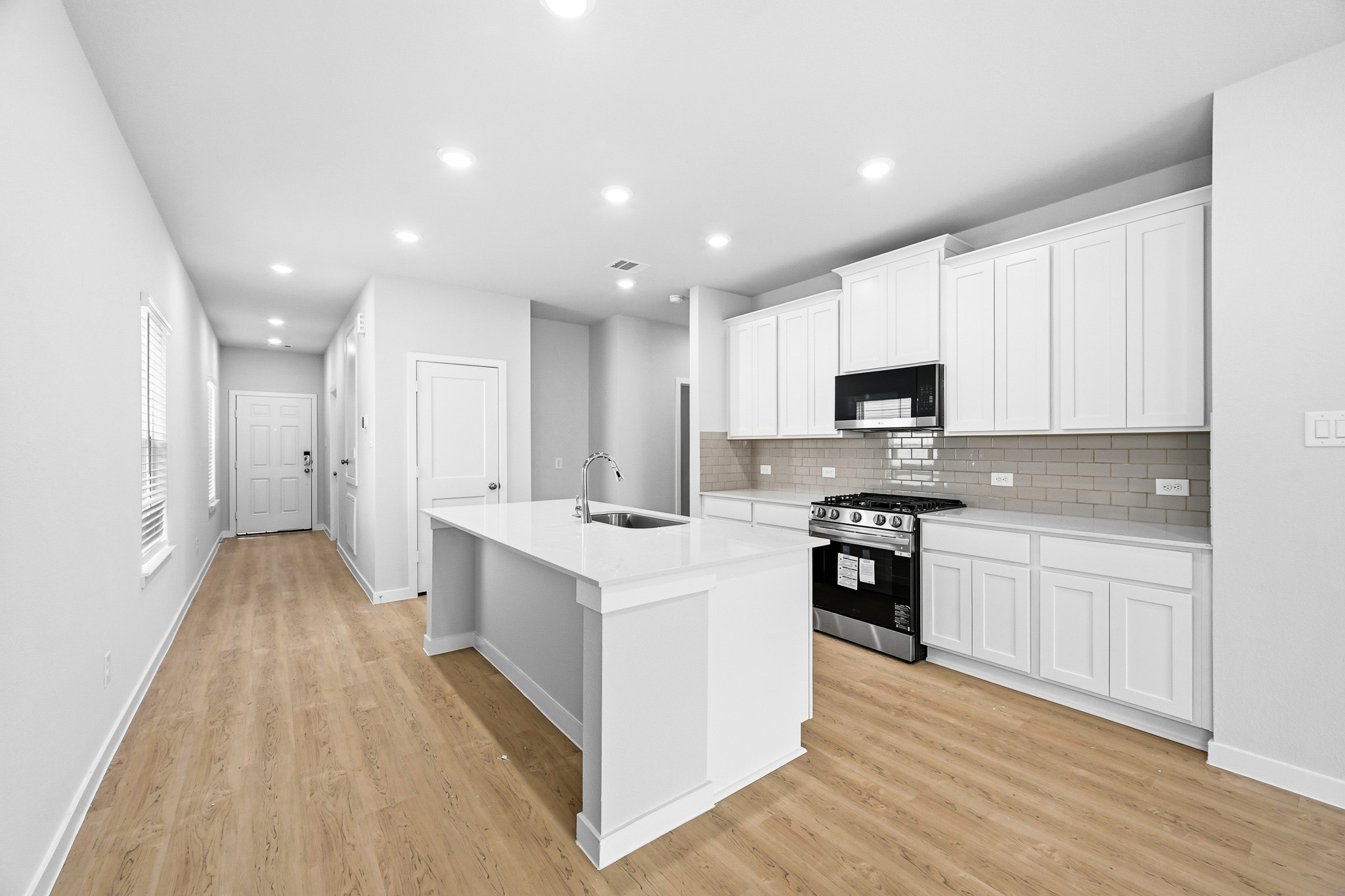 A kitchen with white cabinets.