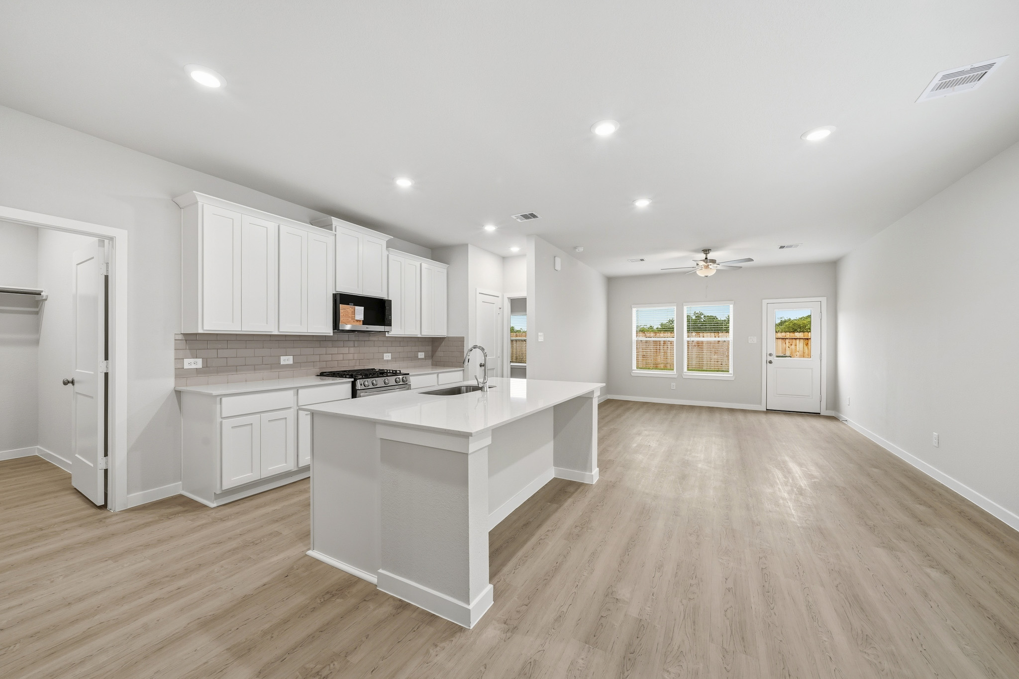 A kitchen with white cabinets.