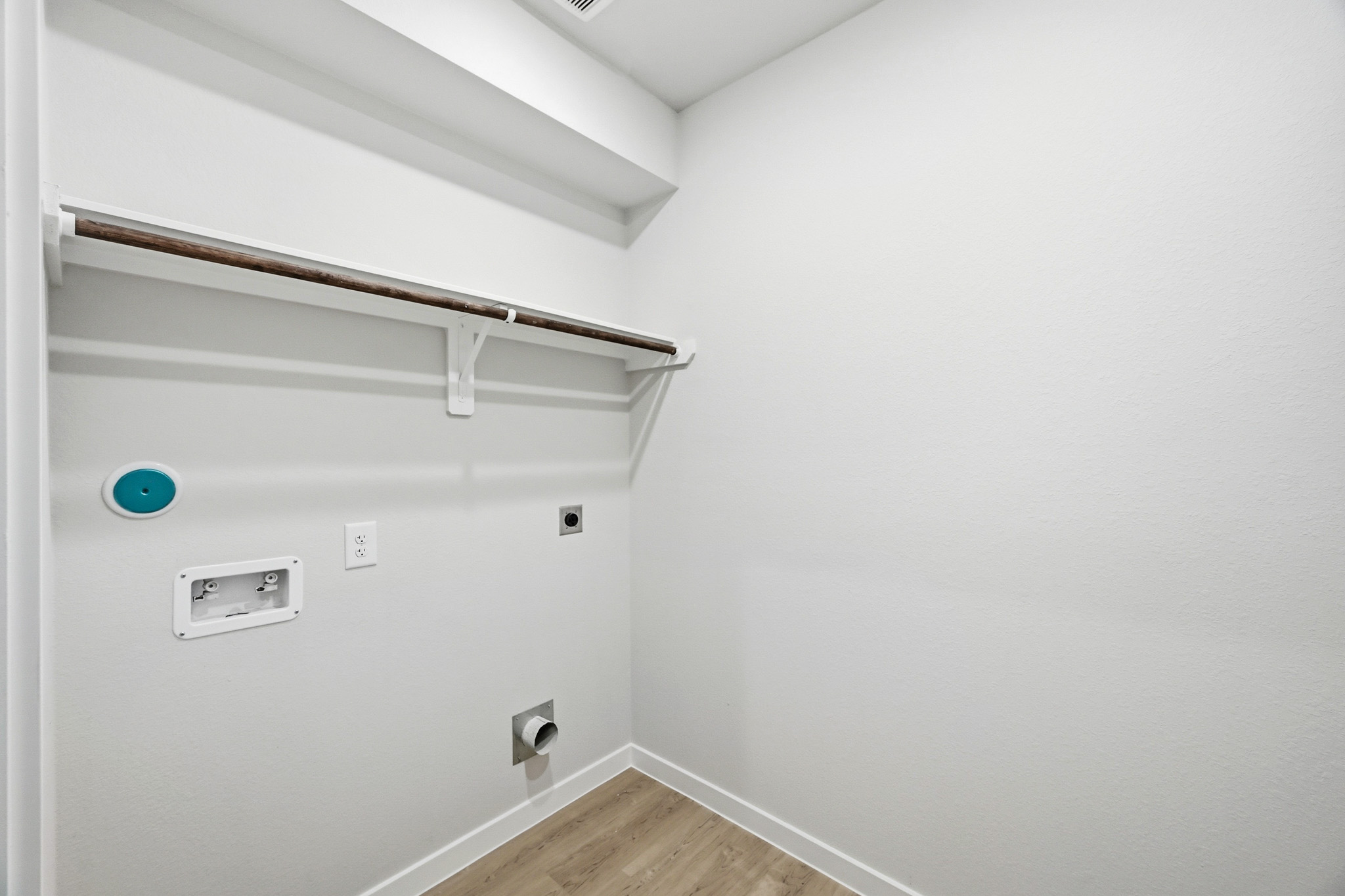 A white wall with a light fixture.