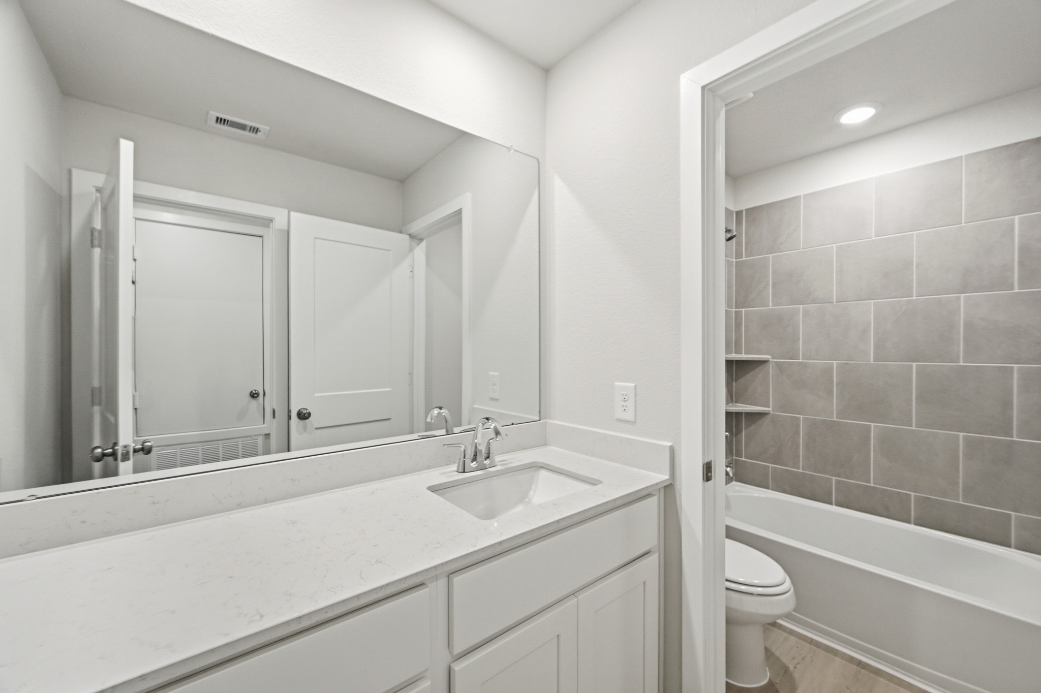 A bathroom with a sink toilet and bathtub.