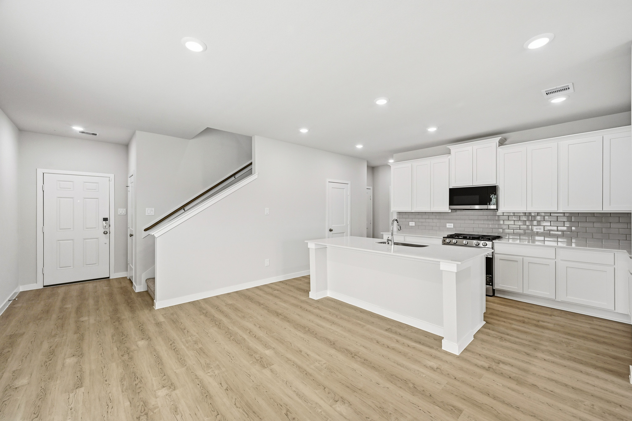 A kitchen with white cabinets.