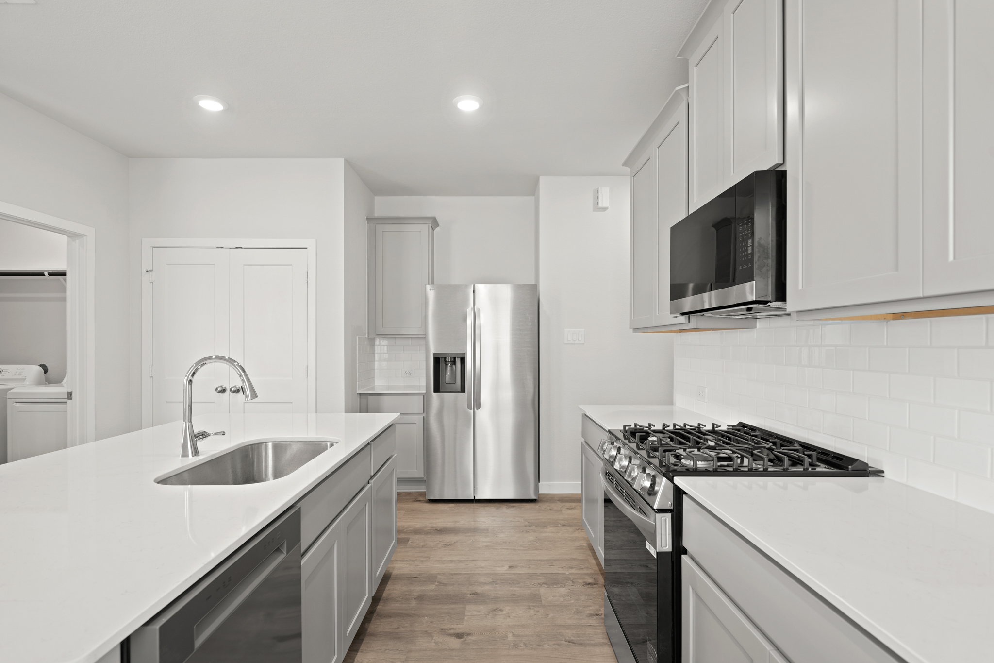 A kitchen with white cabinets.