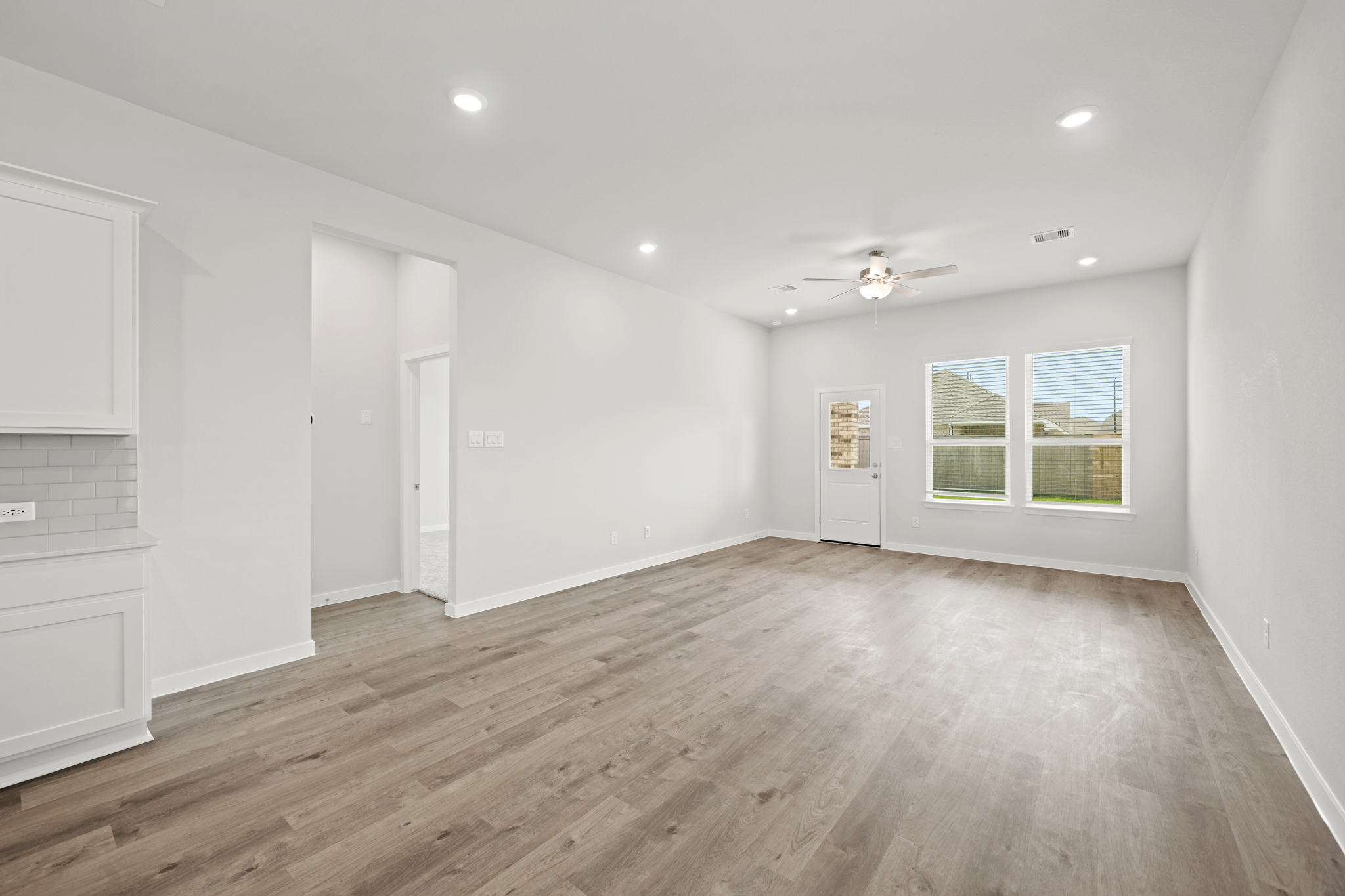 A room with white walls and a wood floor.