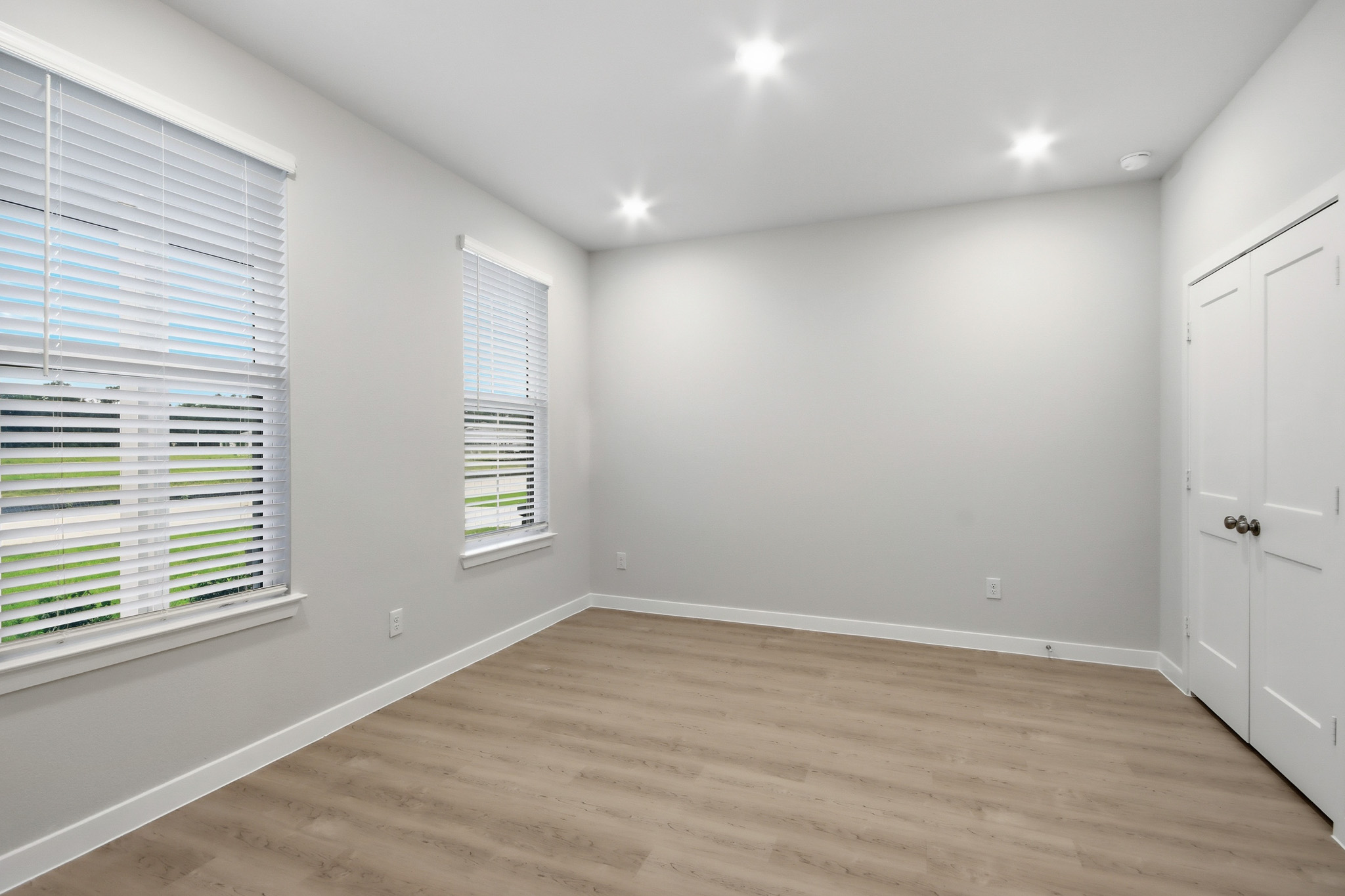 A room with a wood floor and white walls.