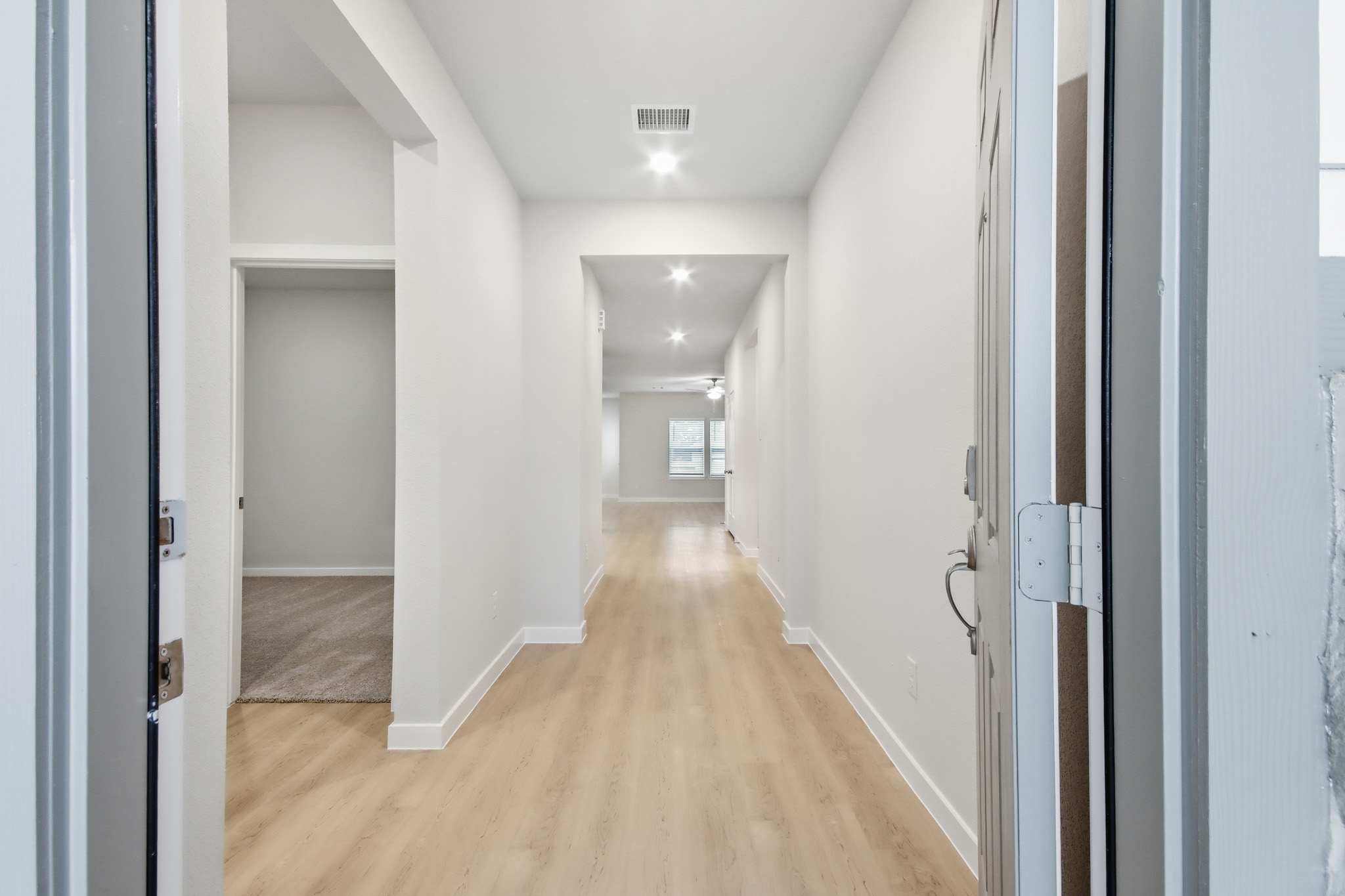 A hallway with white walls.
