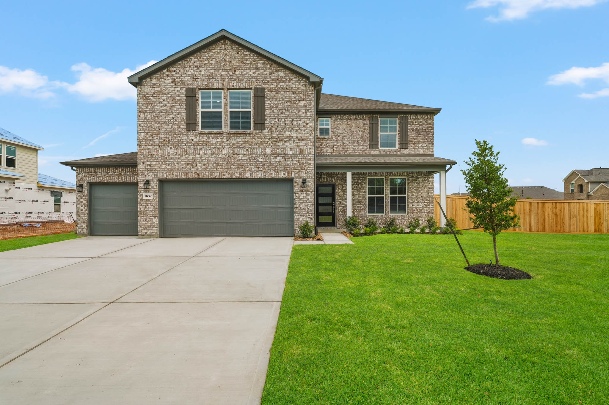 A house with a garage and a lawn.