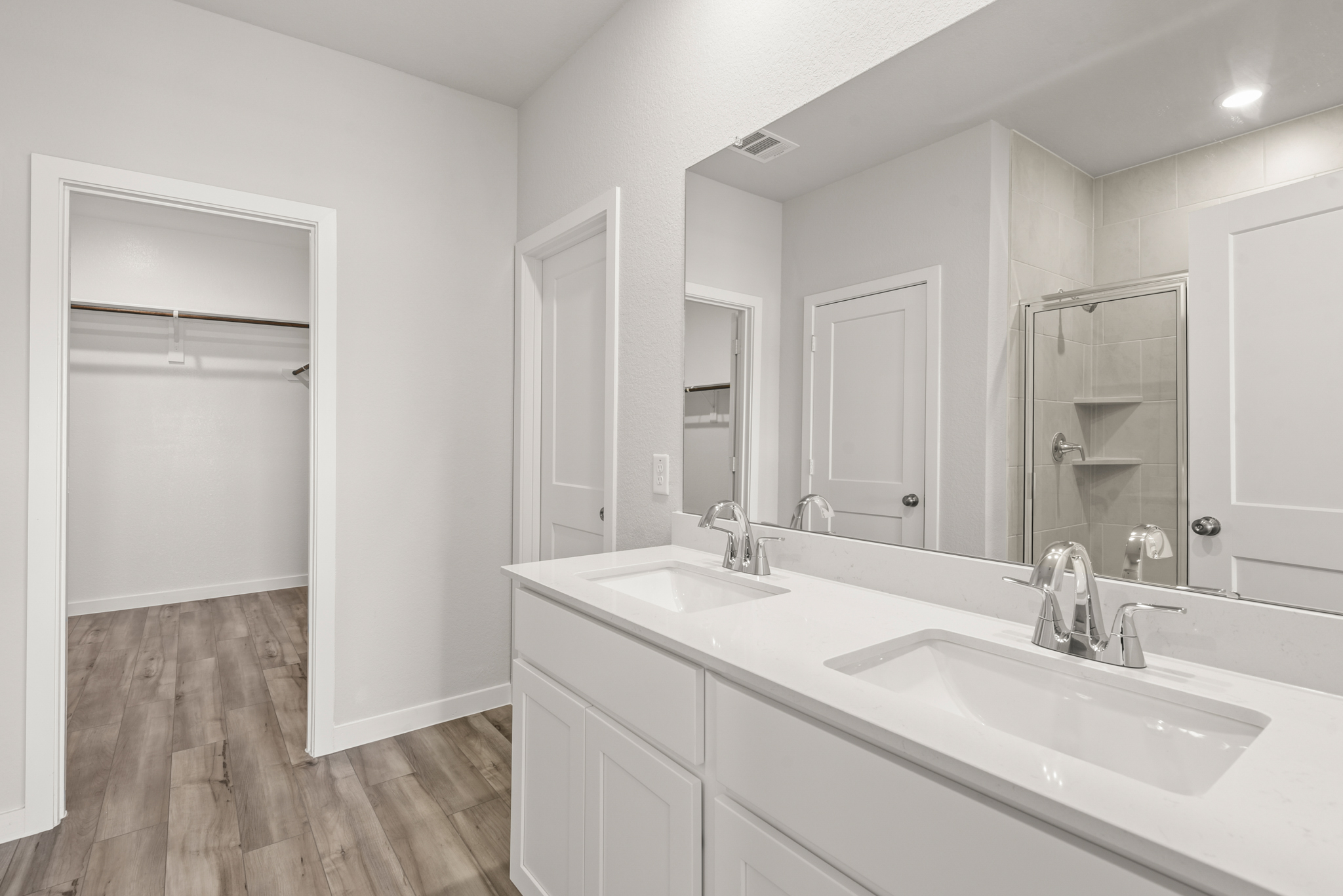 A bathroom with white cabinets.