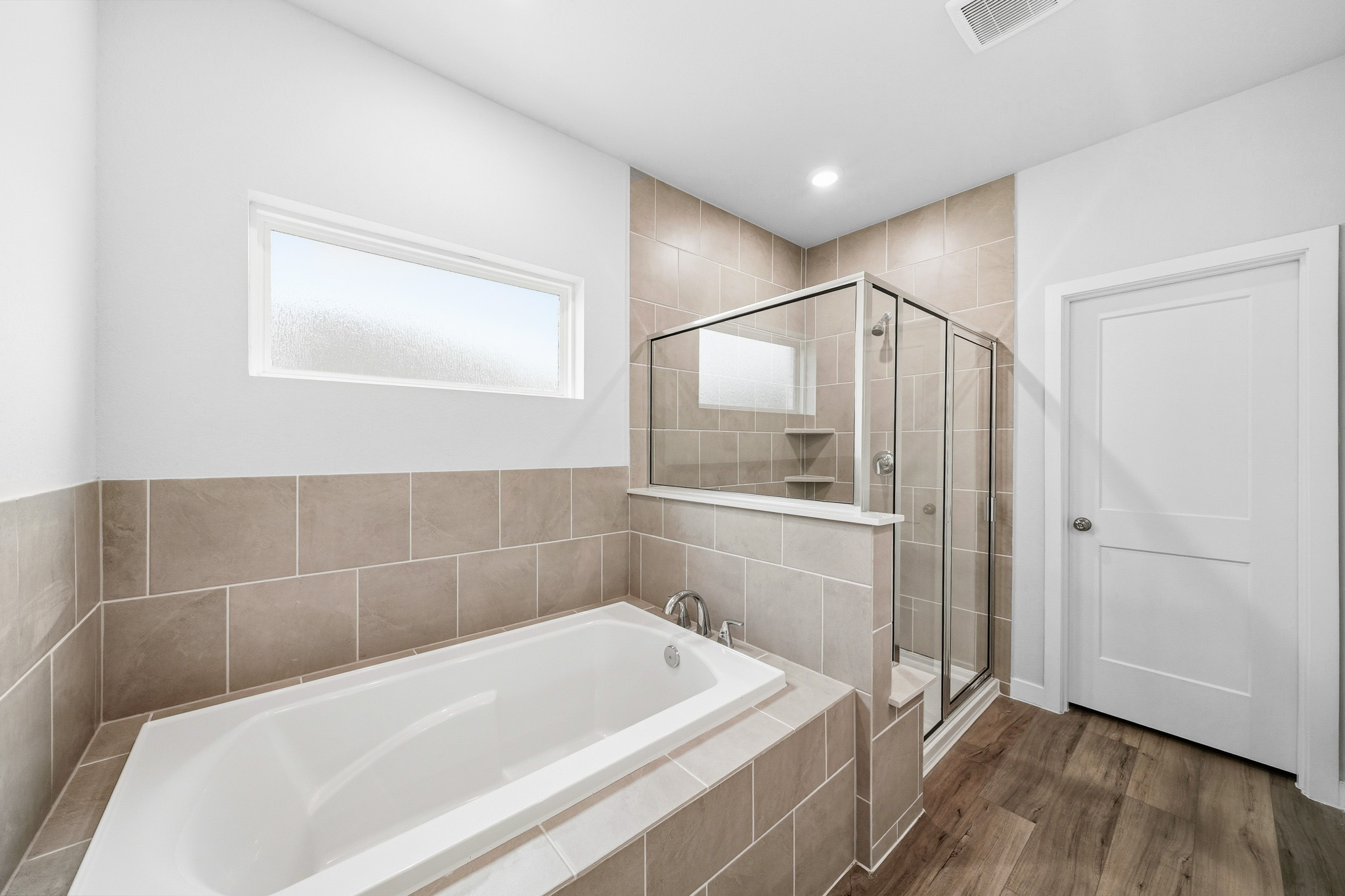 A bathroom with a tub and shower.