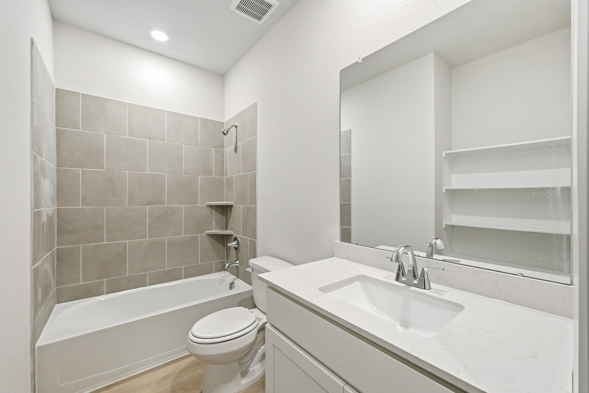 A bathroom with a sink toilet and bathtub.