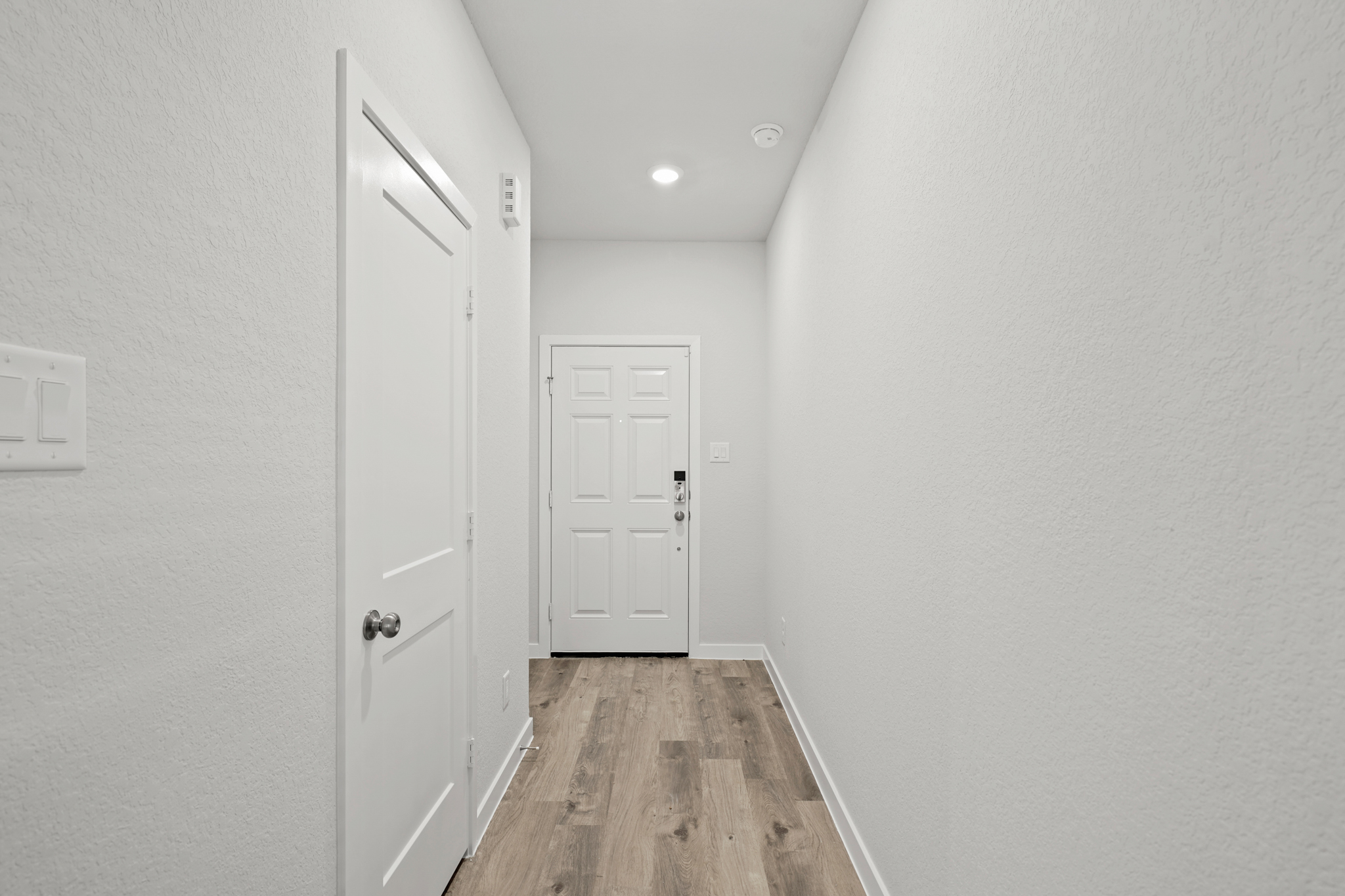 A hallway with white doors.