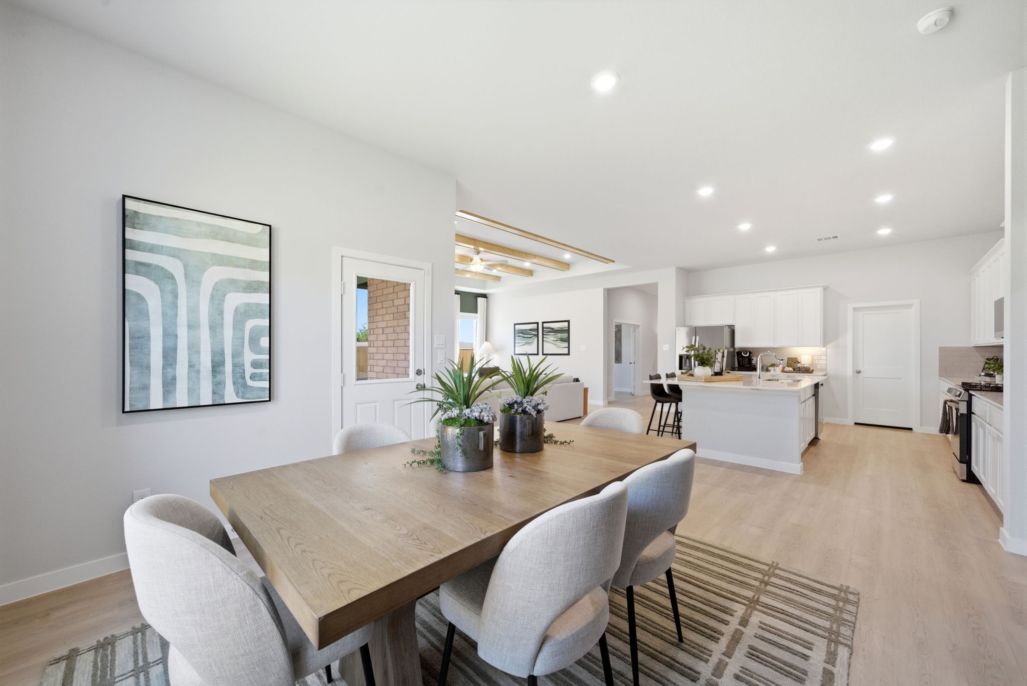 A dining room with a table and chairs.