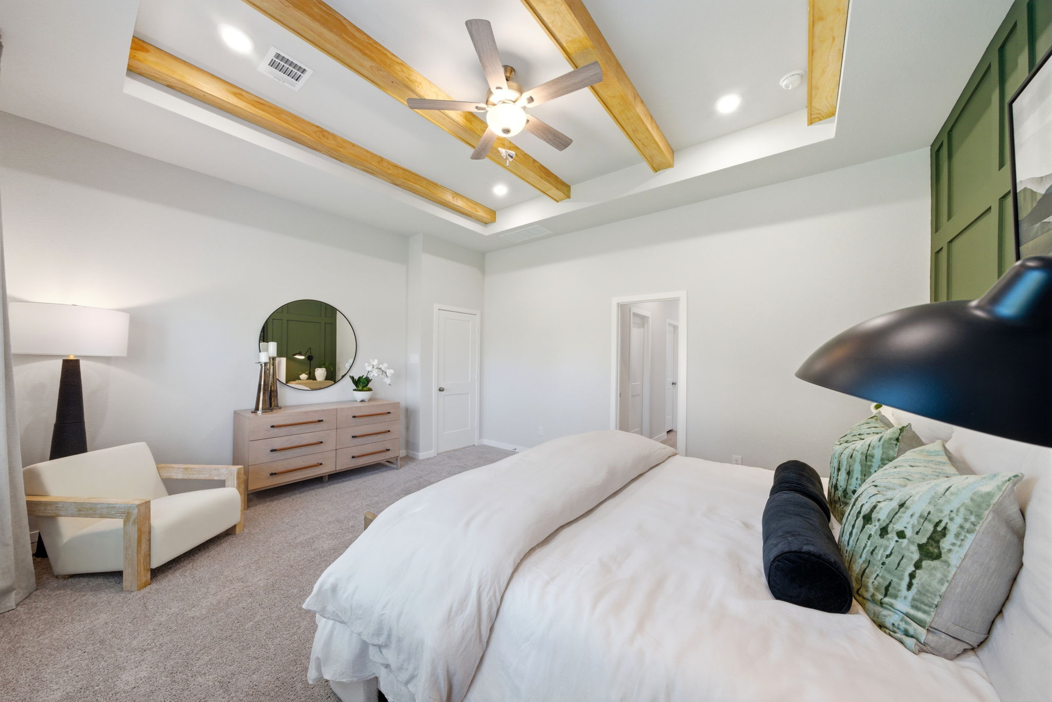 A bedroom with a bed and a fan.
