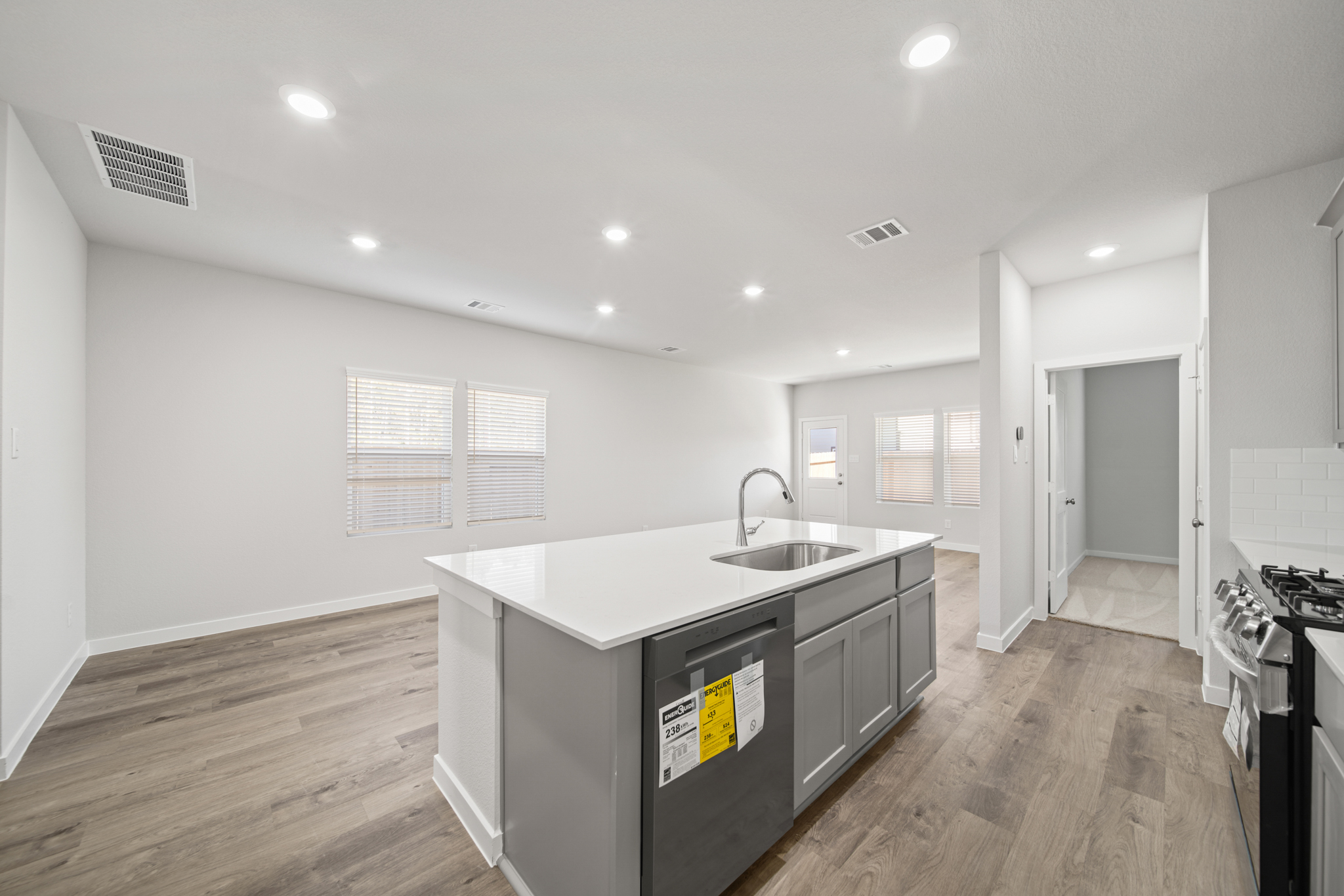 A kitchen with a sink and a stove.