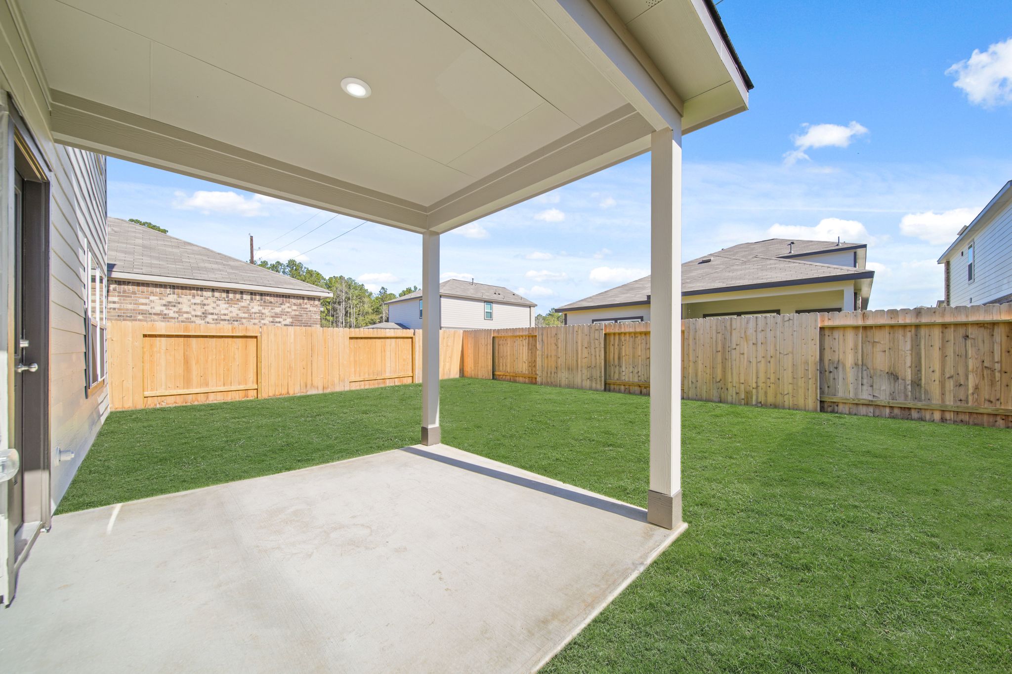A backyard with a fence and a wood fence.