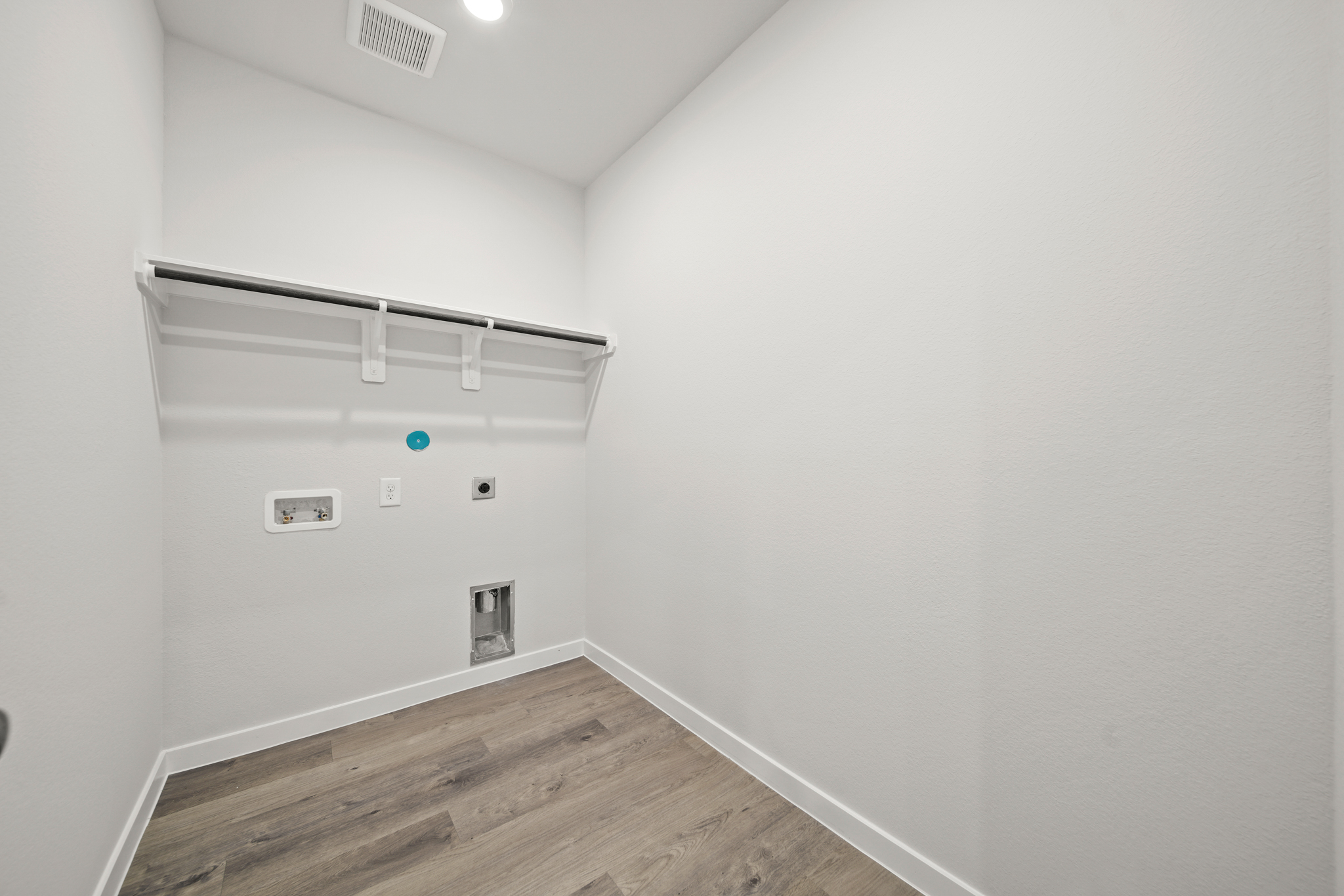 A room with a wood floor and white walls.