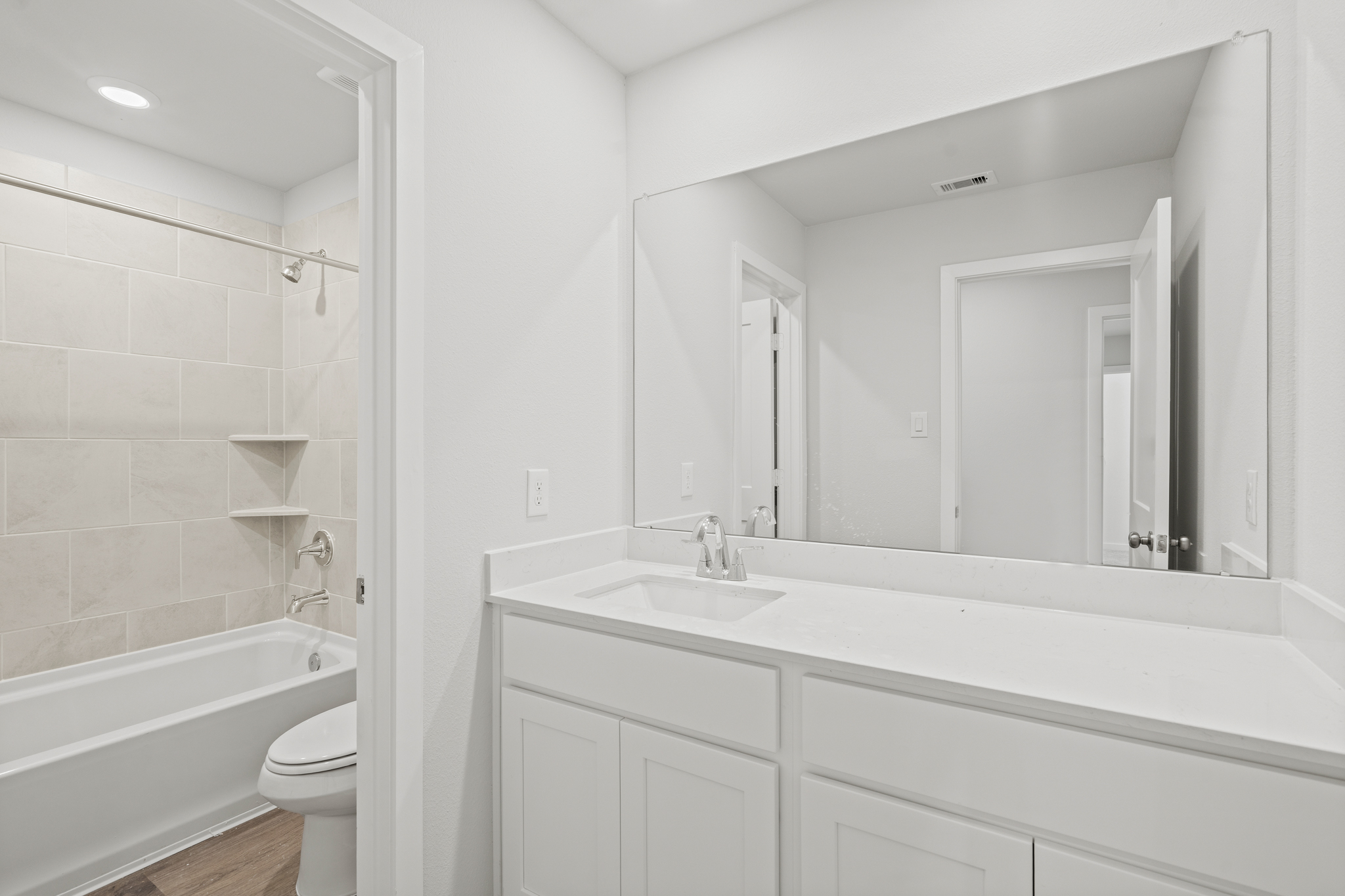 A bathroom with a tub sink and toilet.