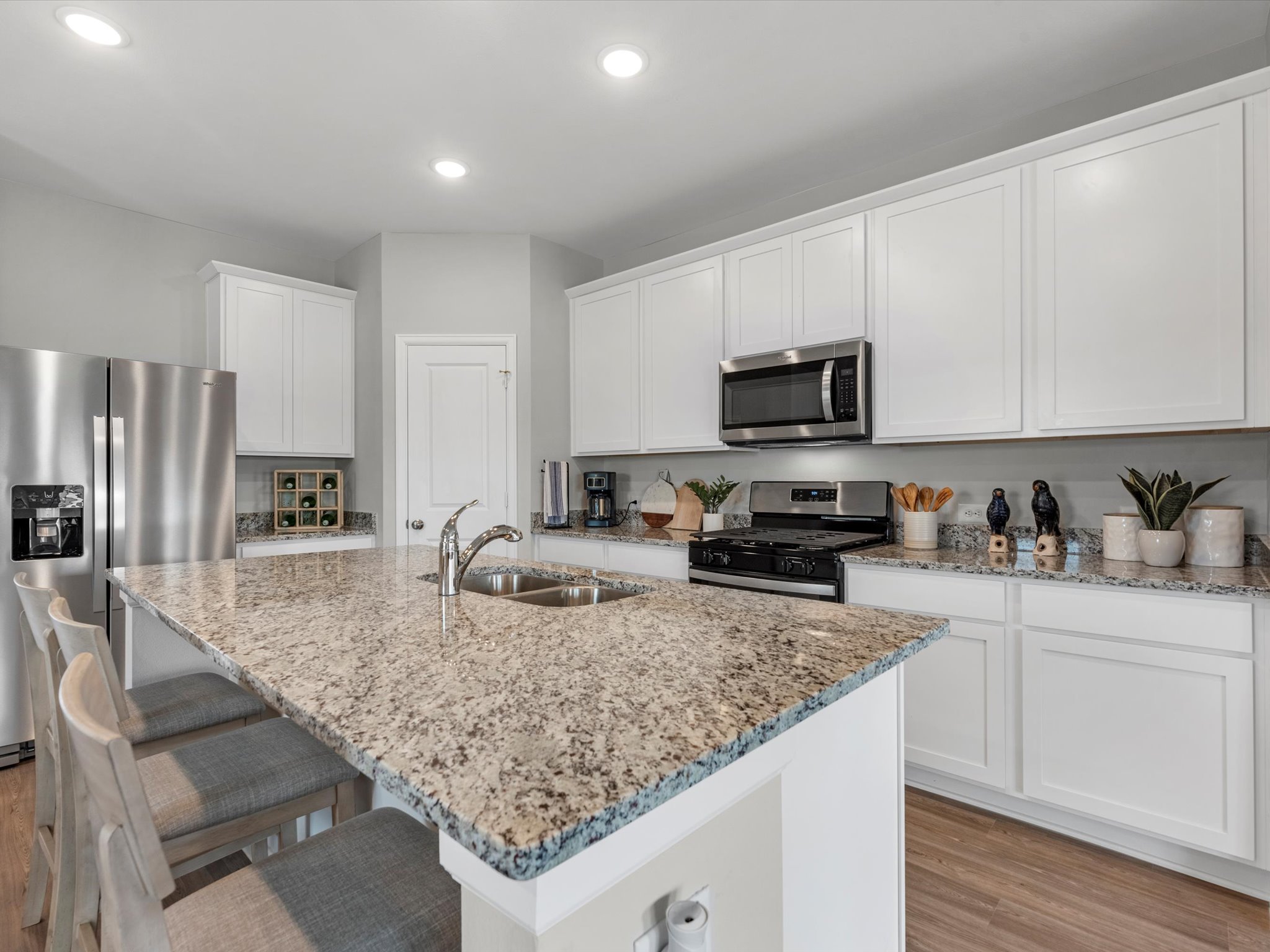 A kitchen with marble counters.