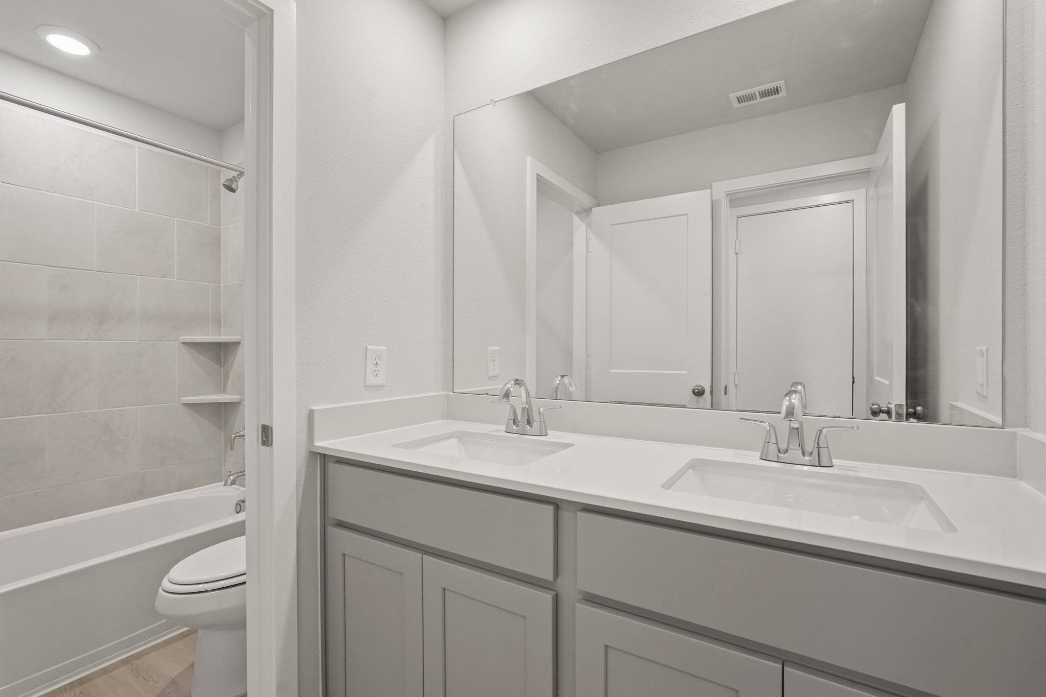 A bathroom with a sink and a toilet.