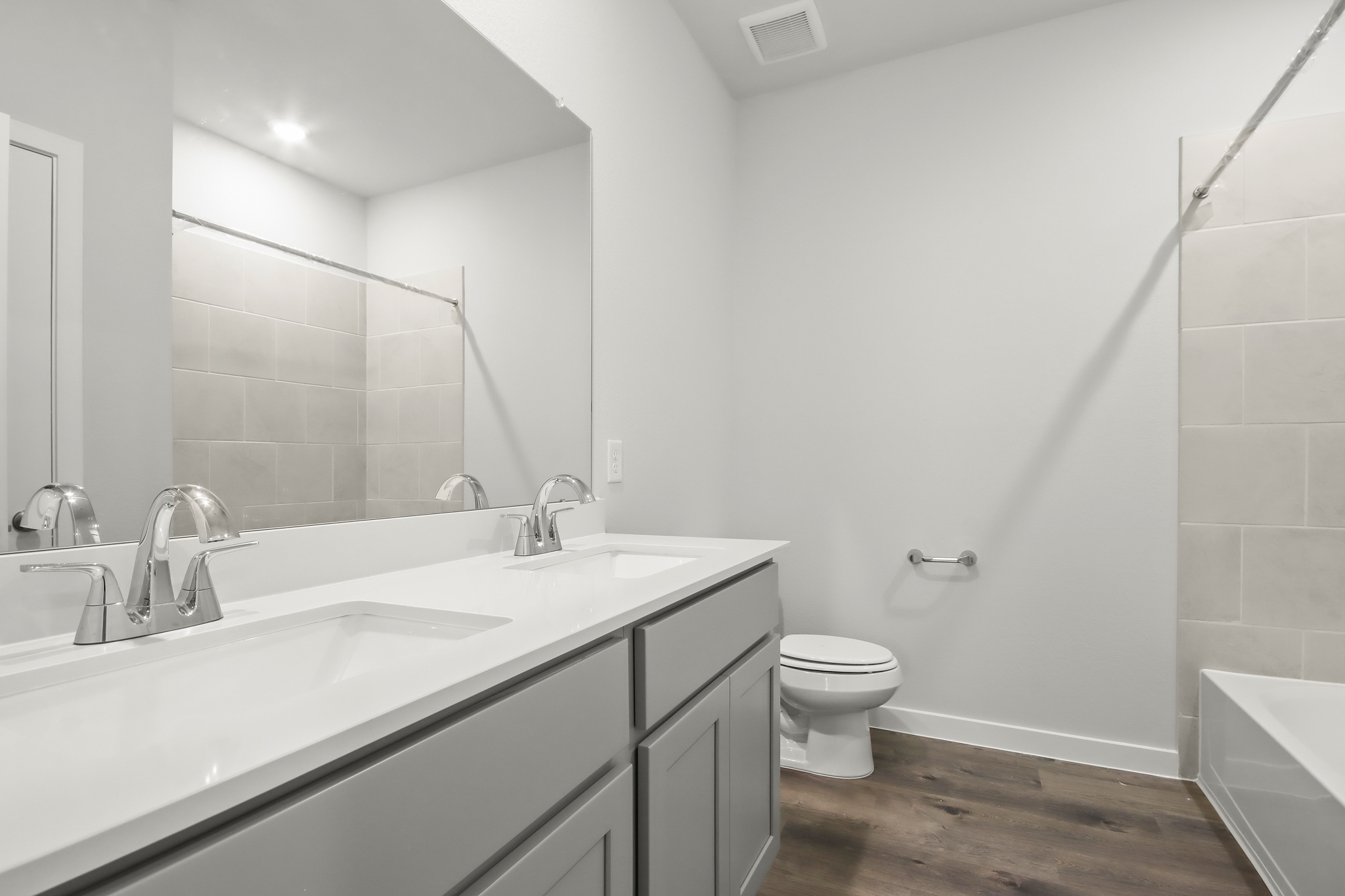 A bathroom with a tub sink and toilet.