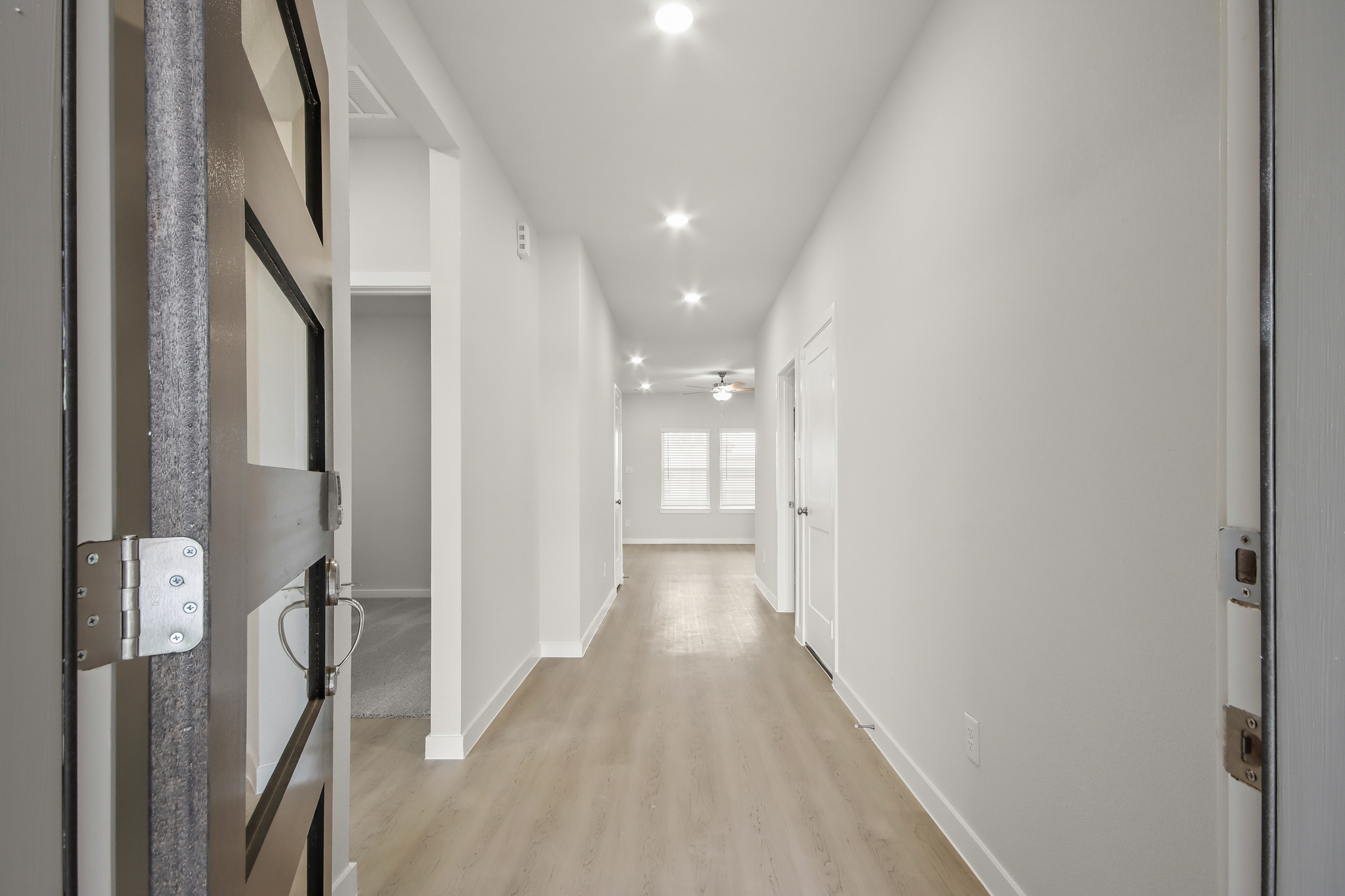 A hallway with white walls.