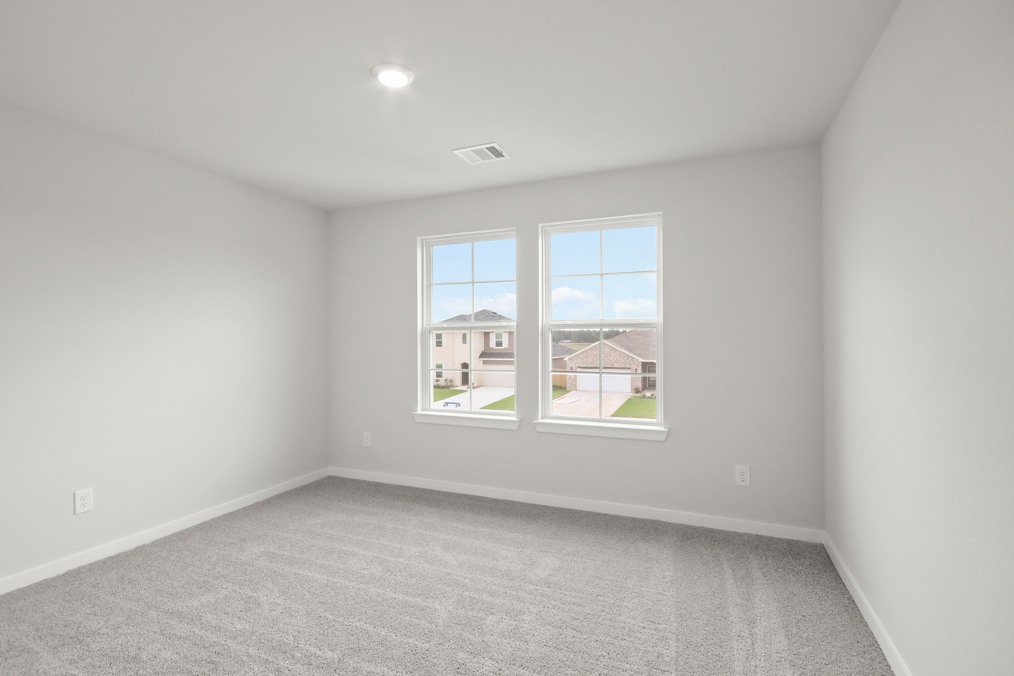 A room with a window and a carpet.