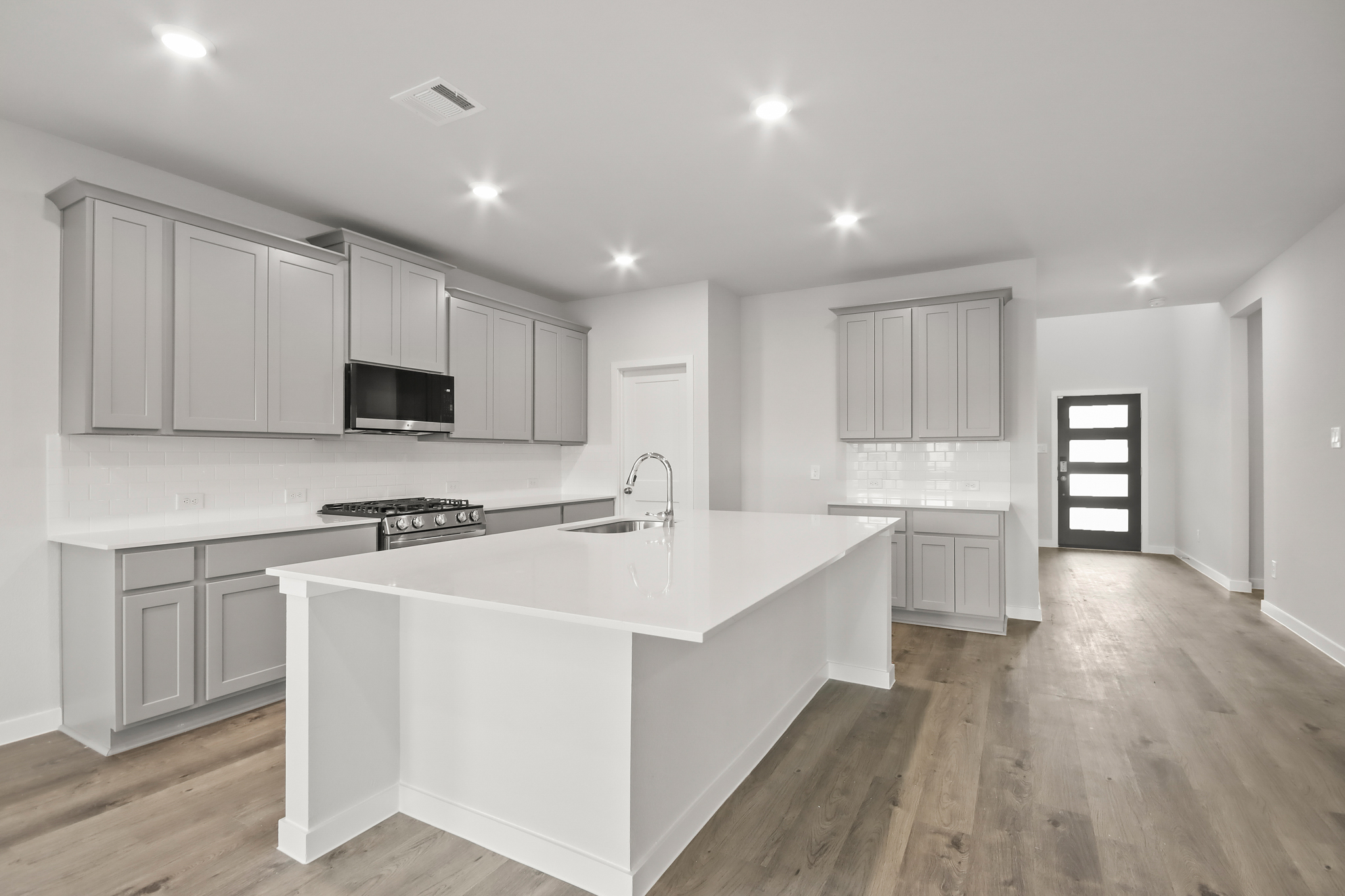 A kitchen with white cabinets.