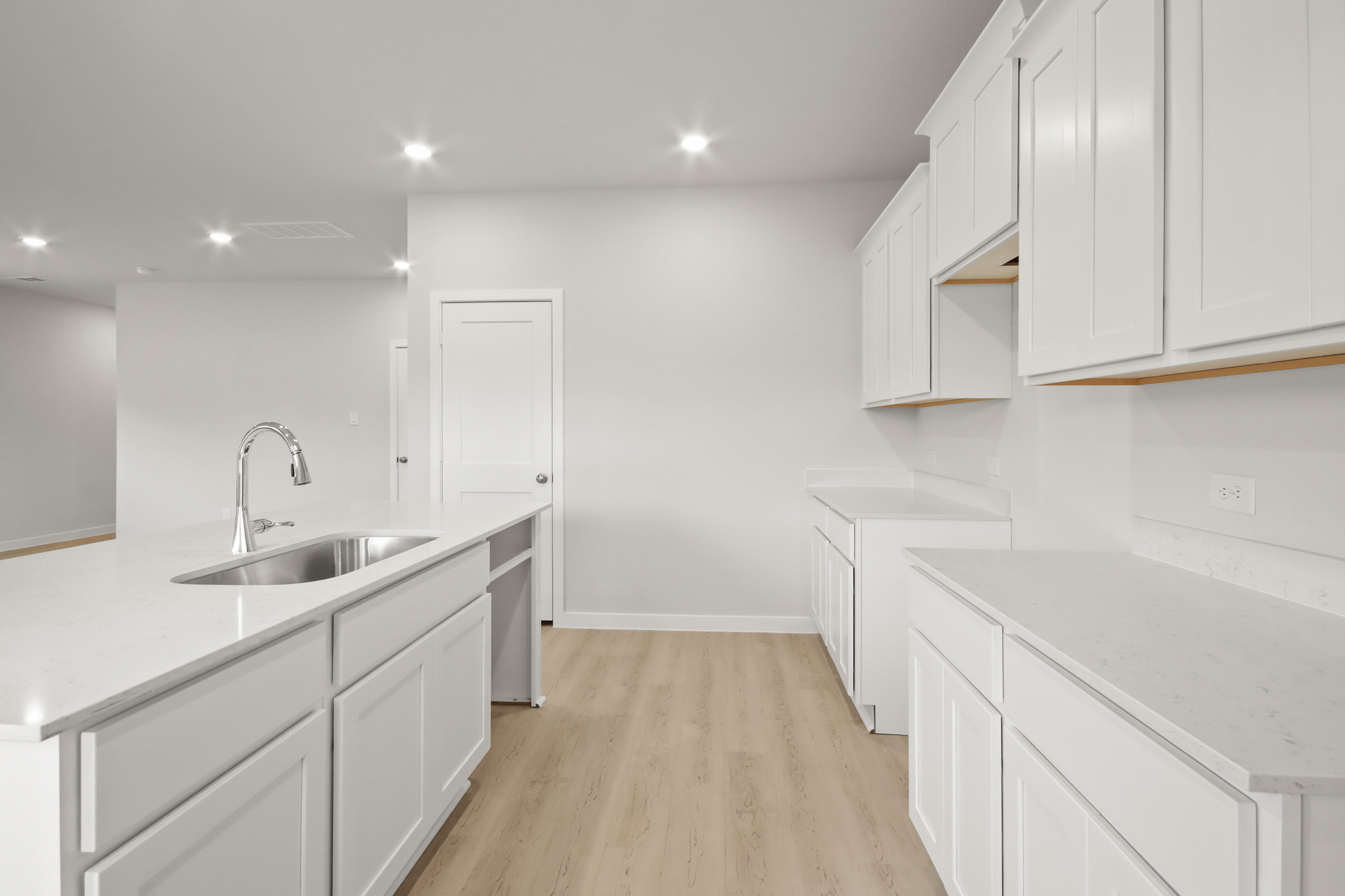 A kitchen with white cabinets.