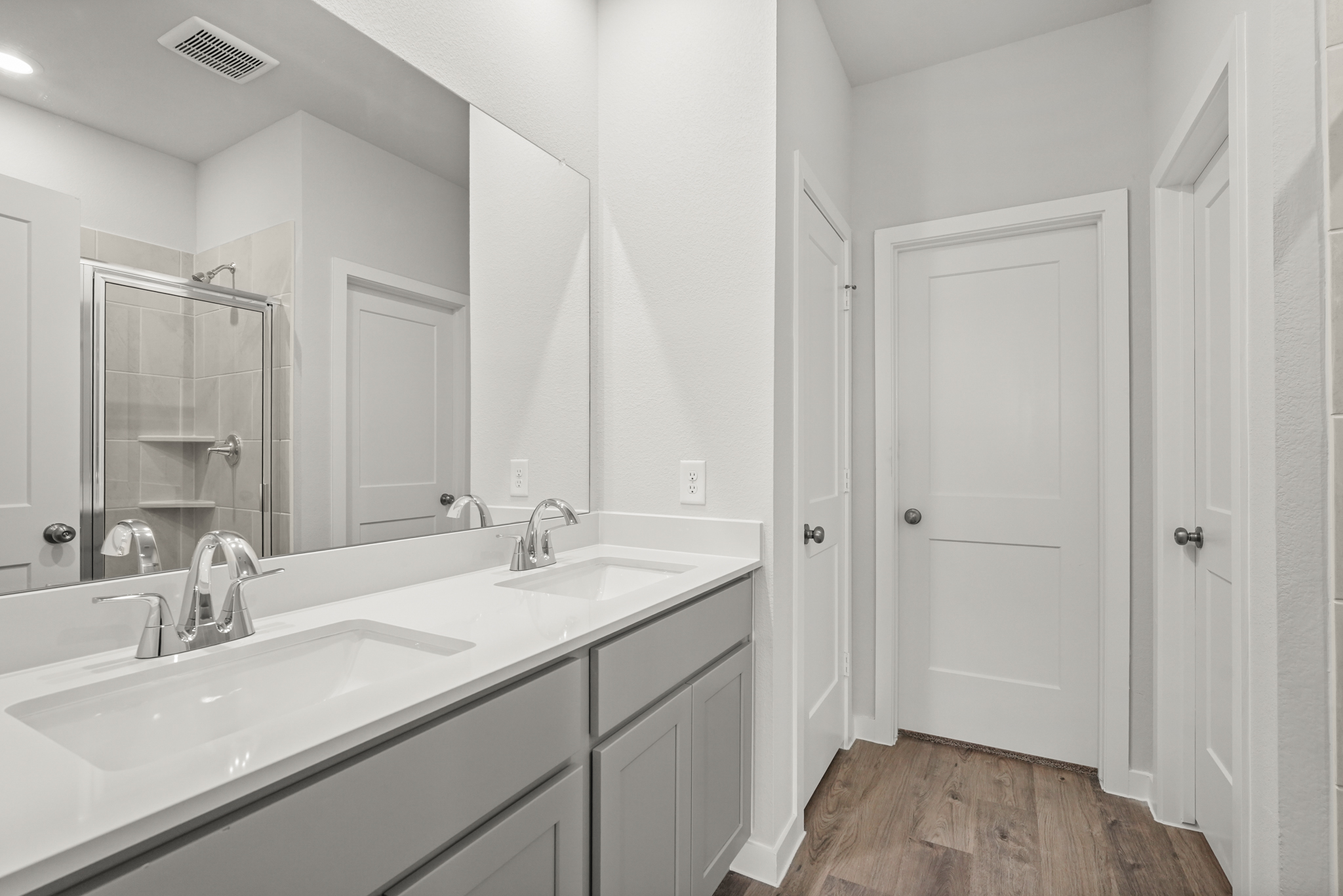 A bathroom with white cabinets.