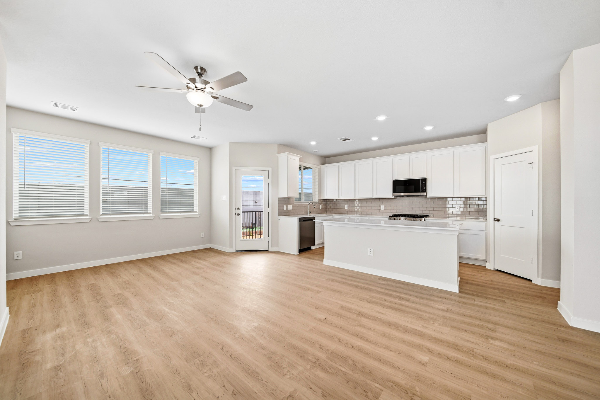 A large kitchen with white cabinets.