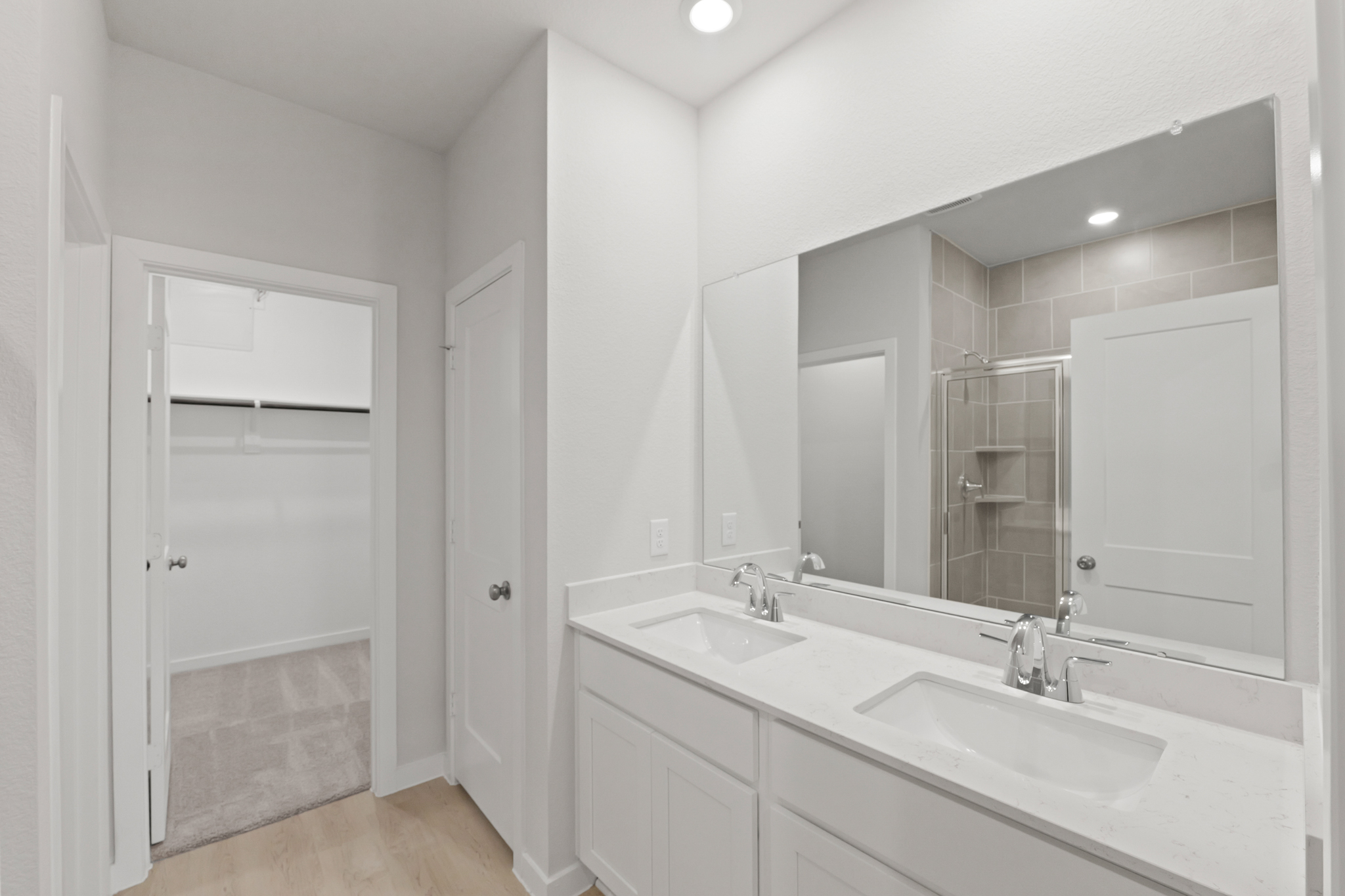A bathroom with a large mirror.