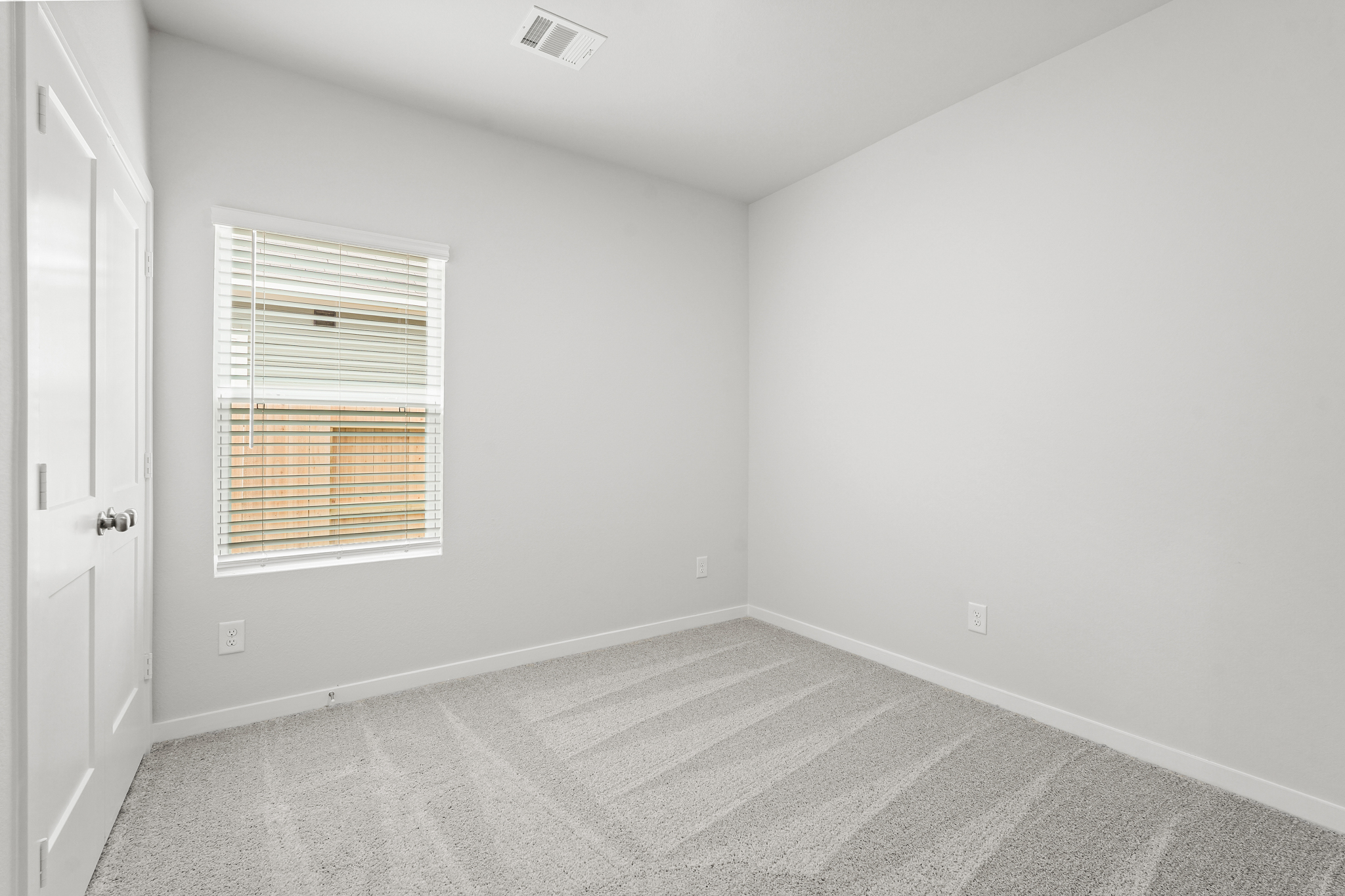 A room with a window and a door.