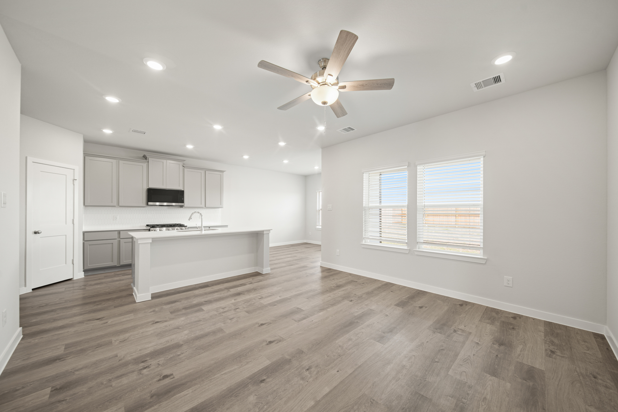 A kitchen with a wood floor.