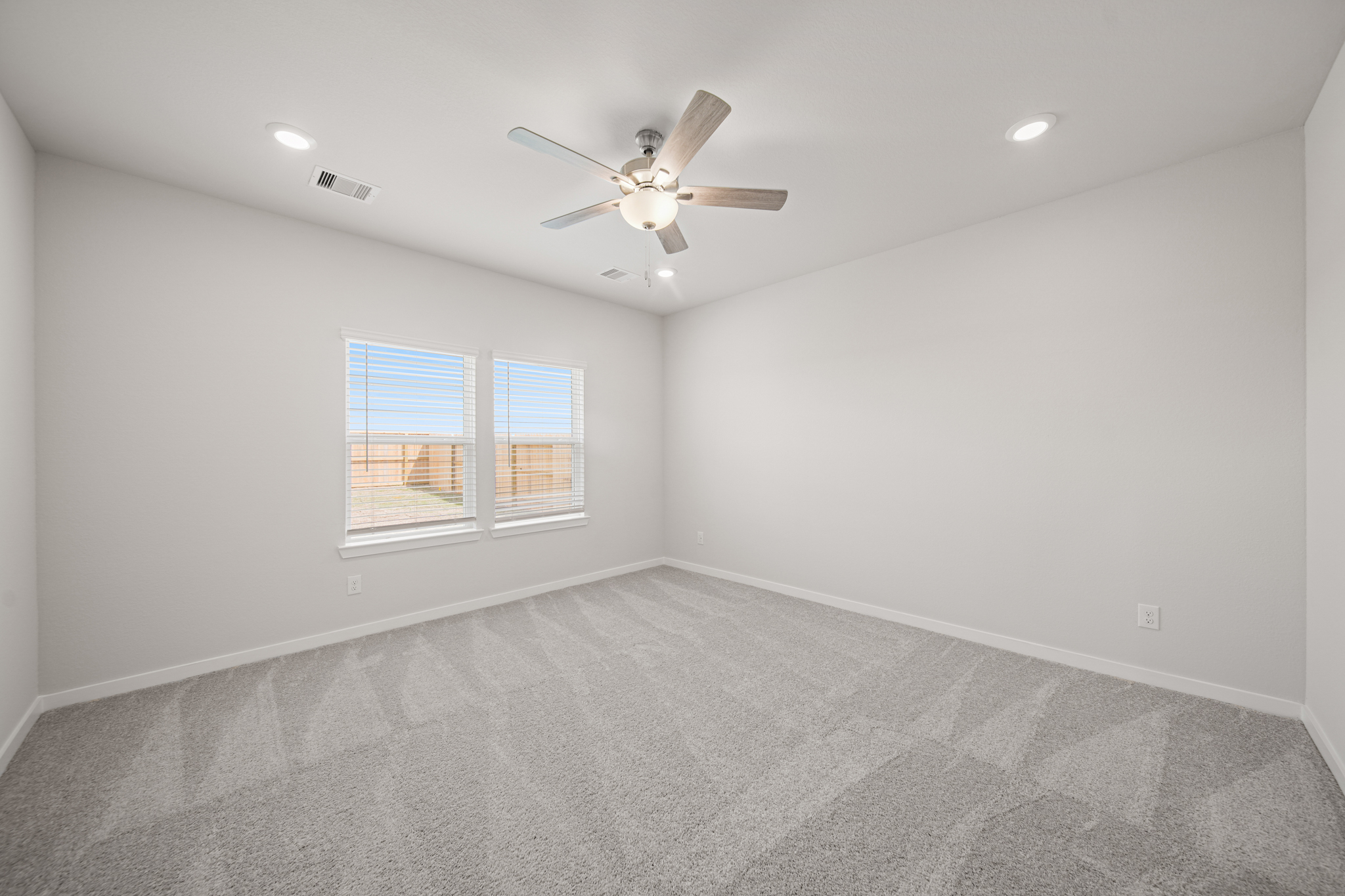 A room with a ceiling fan and a ceiling fan.