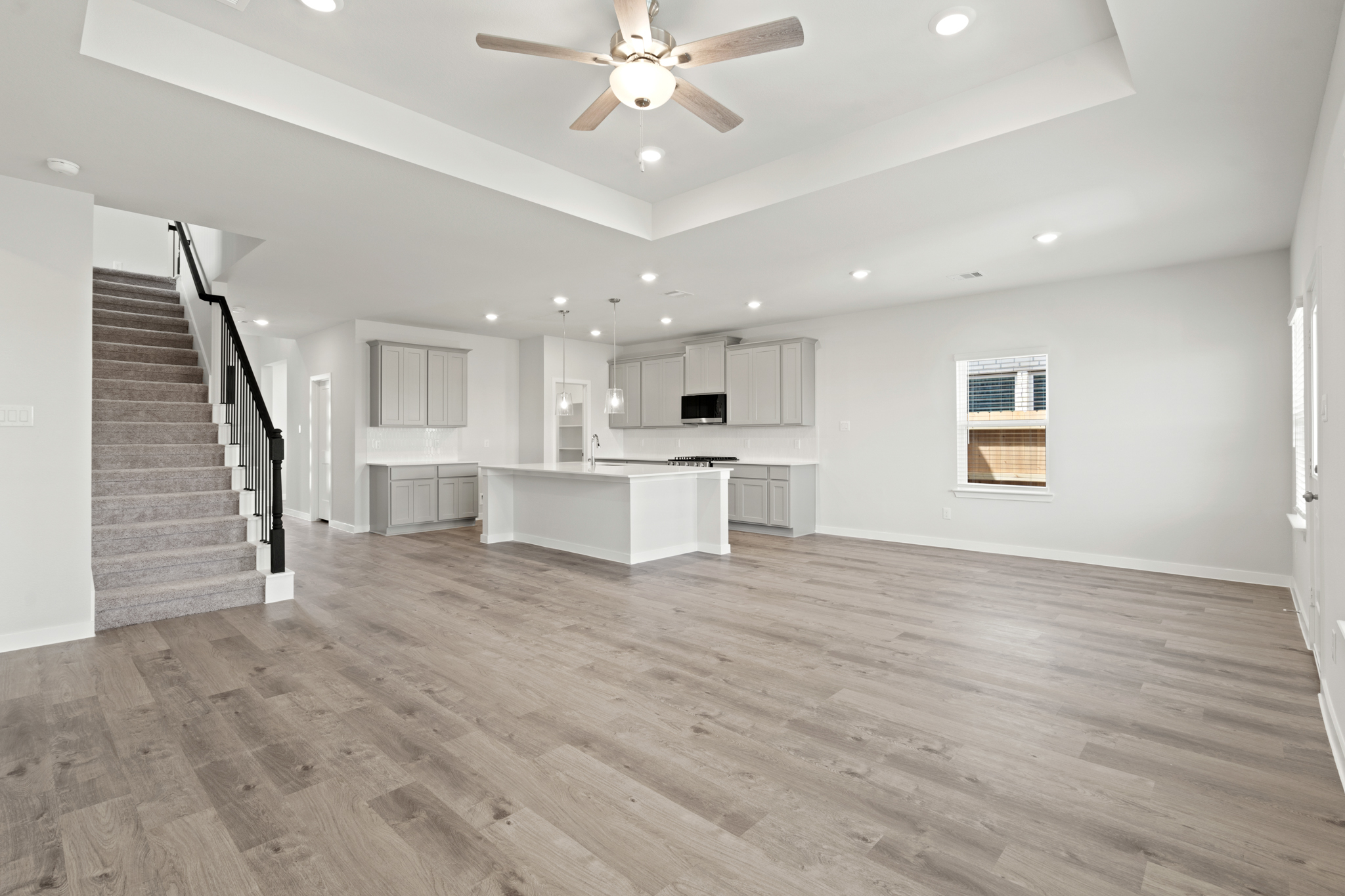 A large kitchen with a wood floor.