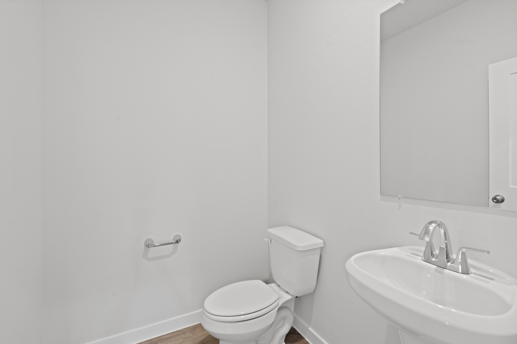 A bathroom with a toilet and sink.