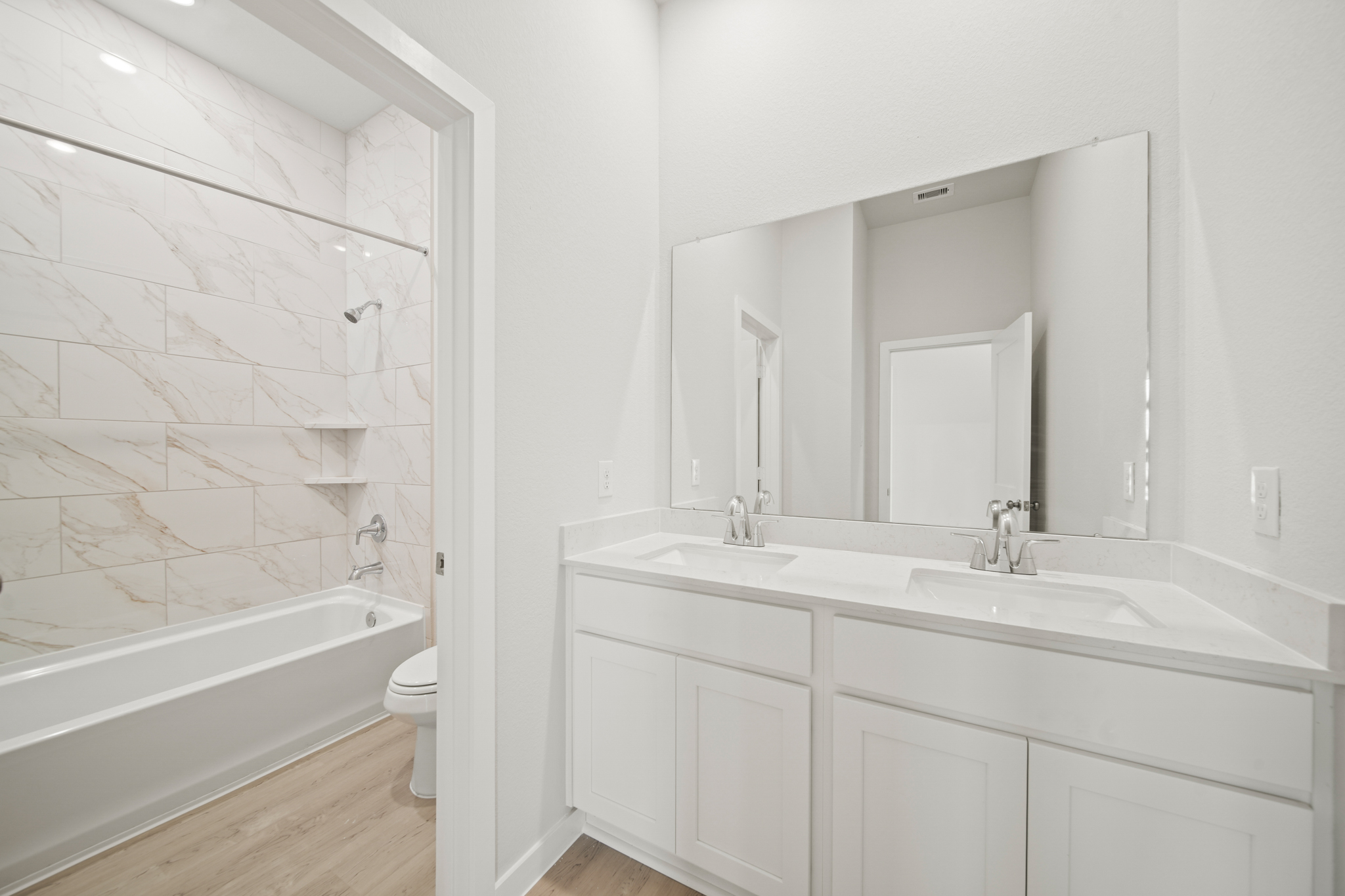 A bathroom with a tub sink and toilet.