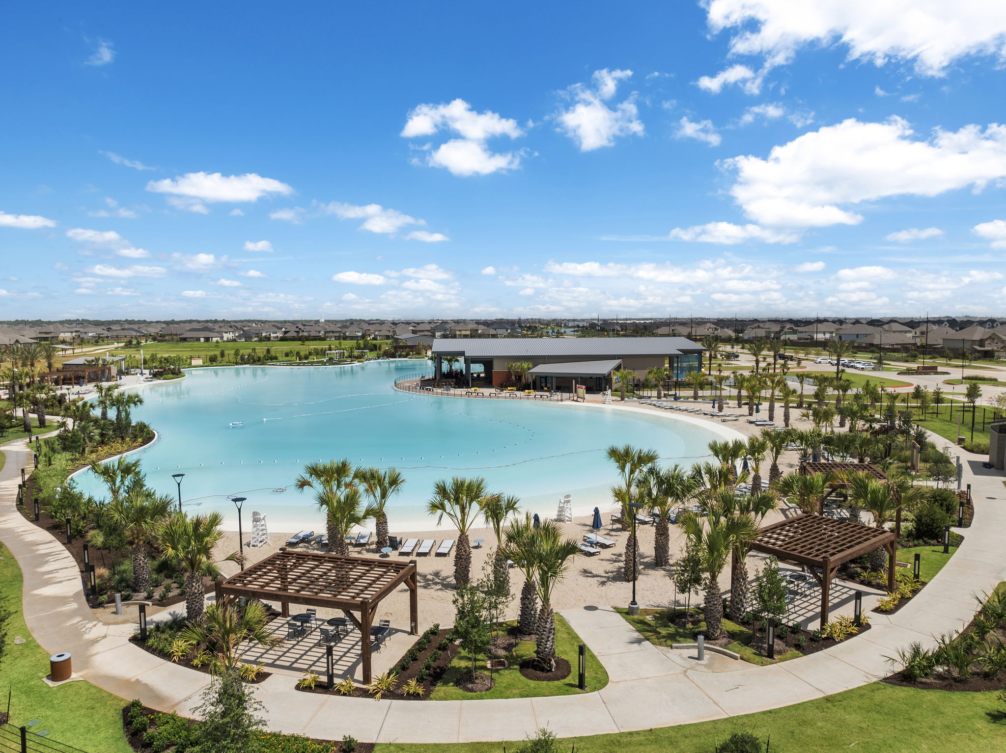 A pool with a building and trees around it.