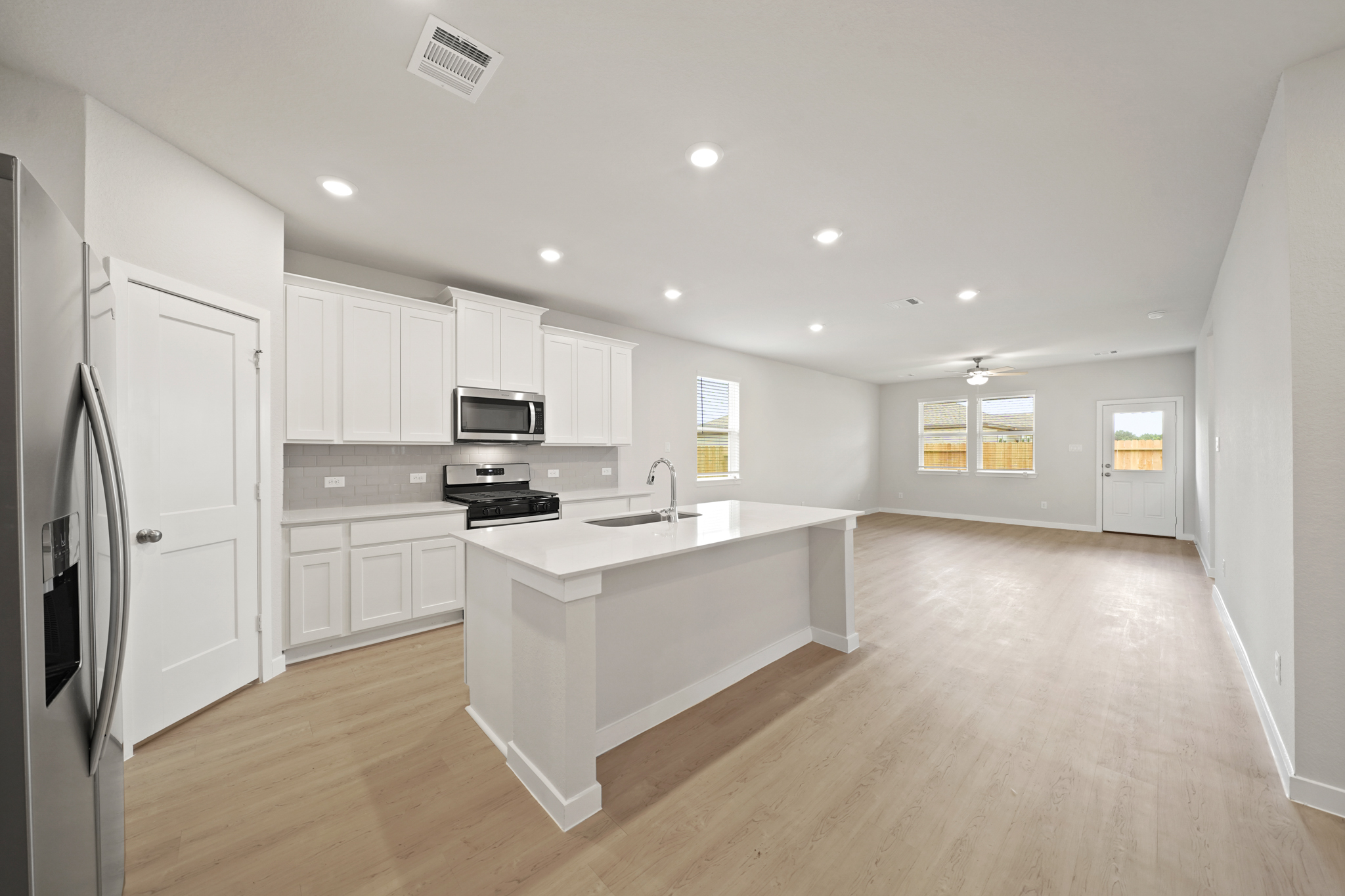 A kitchen with white cabinets.